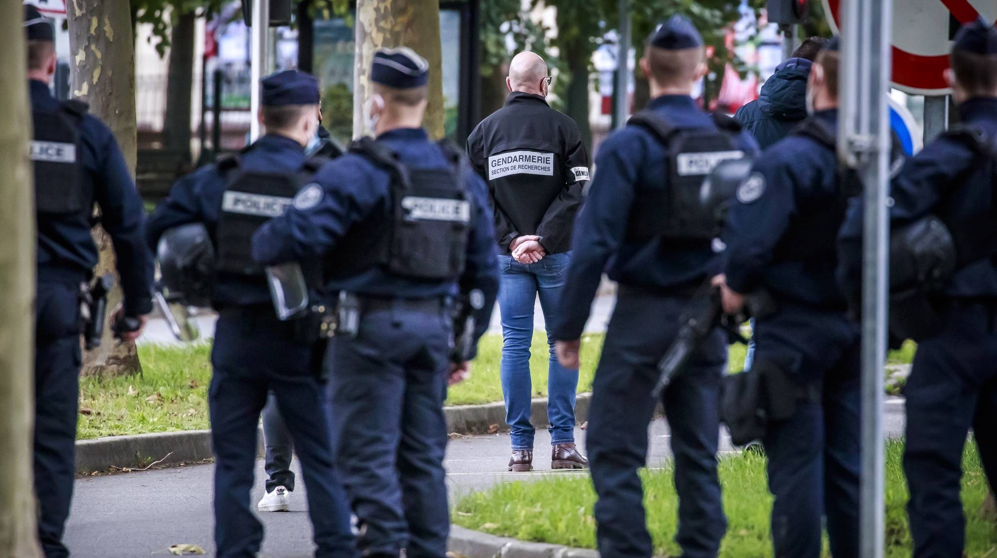 epa08749064 French police officers stand guard ahead of the arrival of French serial killer Michel Fourniret (unseen) in Guermantes, near Paris, France, 15 October 2020. On 09 January 2003, Estelle Mouzin, a nine-year-old girl, disappeared on the way back from school in Guermantes. French serial killer Michel Fourniret aka The Ogre of the Ardennes and his ex-wife Monique Olivier were removed from prison and transported to the scene of the disappearance of Estelle Mouzin, for police investigation and reenactment.  EPA/CHRISTOPHE PETIT TESSON