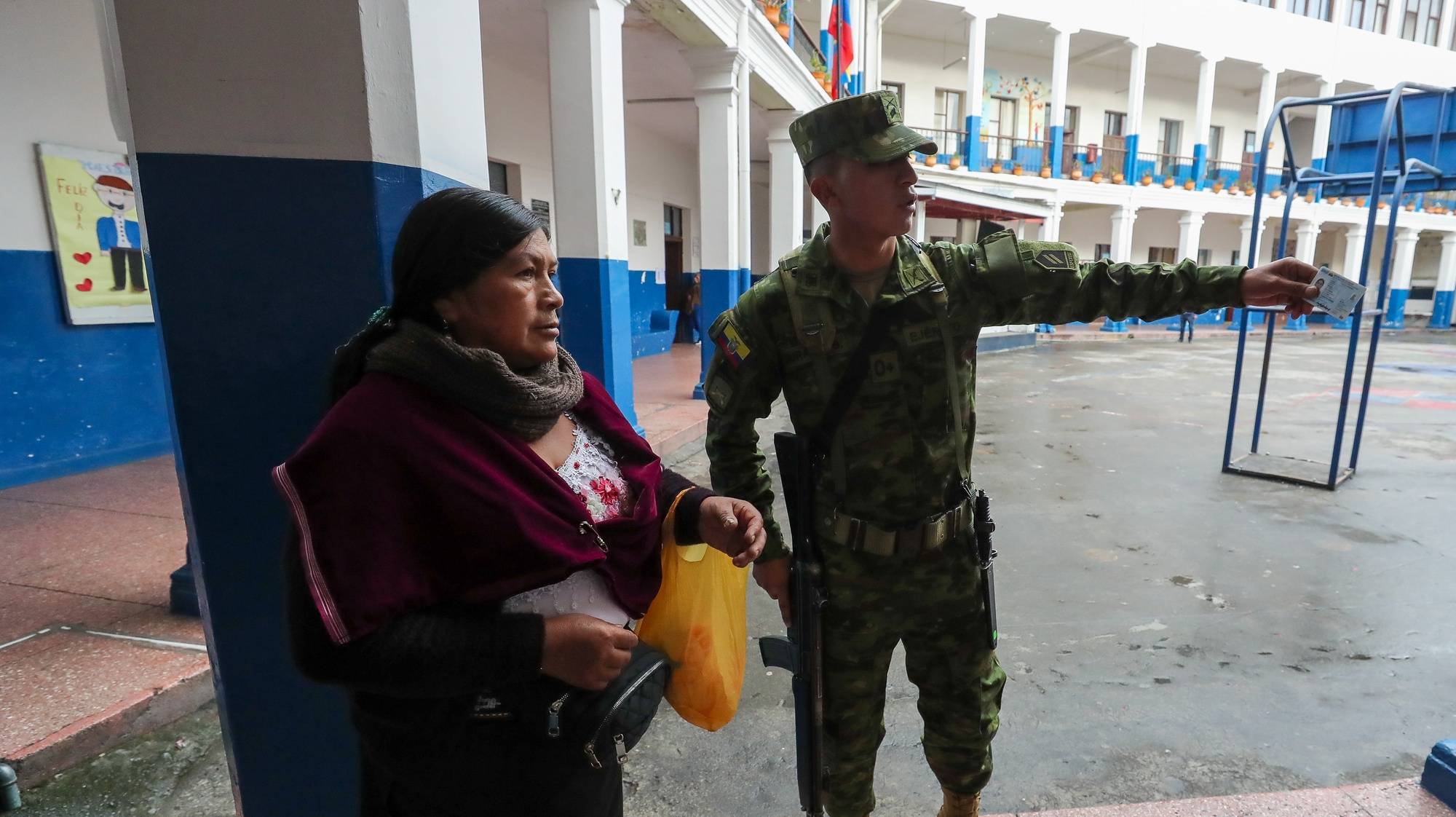 epa11292106 A woman receives information to find her place to vote in a referendum proposed by Ecuador&#039;s government in Olon, Ecuador, 21 April 2024. Ecuadorians are called to vote on a referendum to decide on issues including security, justice, investments, and employment on 21 April.  EPA/Jose Jacome