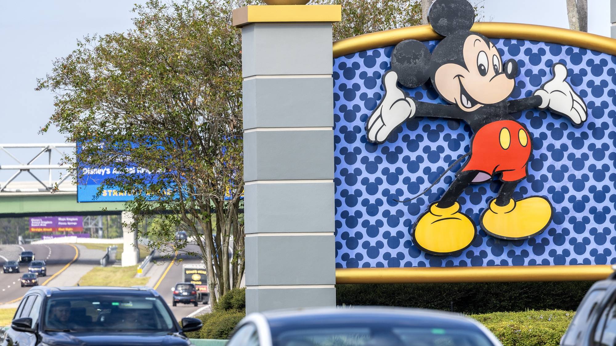 epa10956851 Cars pass next to one of the Walt Disney World signs in Kissimmee, Florida, USA, 03 November 2023. Florida Governor Ron DeSantis, a candidate for the 2024 GOP presidential nomination, seized this year the administrative area of Disney World in Orlando and appointed new managers to run it, dissolving independent special districts that were created prior to 1968.  EPA/CRISTOBAL HERRERA-ULASHKEVICH