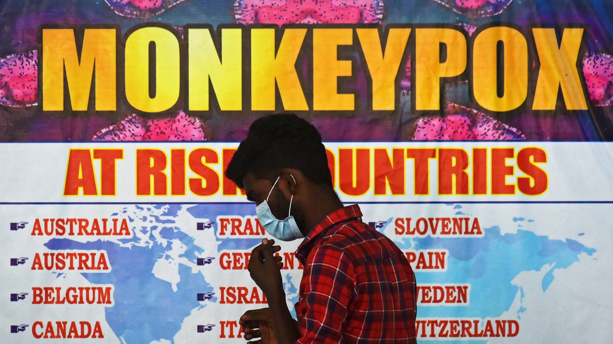 epa10334196 (FILE) - An Indian health worker walks in front of a list of high-risk countries for the Monkeypox virus, at Chennai International Airport, in Chennai, India, 16 July 2022 (reissued 28 November 2022). The World Health Organization (WHO) in a statement on 28 November 2022 said it &quot;will begin using a new preferred term mpox as a synonym for monkeypox&quot; simultaneously for one year until the term &#039;monkeypox&#039; is phased out. The decsion was taken after consultations with global experts as &quot;racist and stigmatizing language online, in other settings and in some communities was observed and reported to WHO.&quot;  EPA/IDREES MOHAMMED