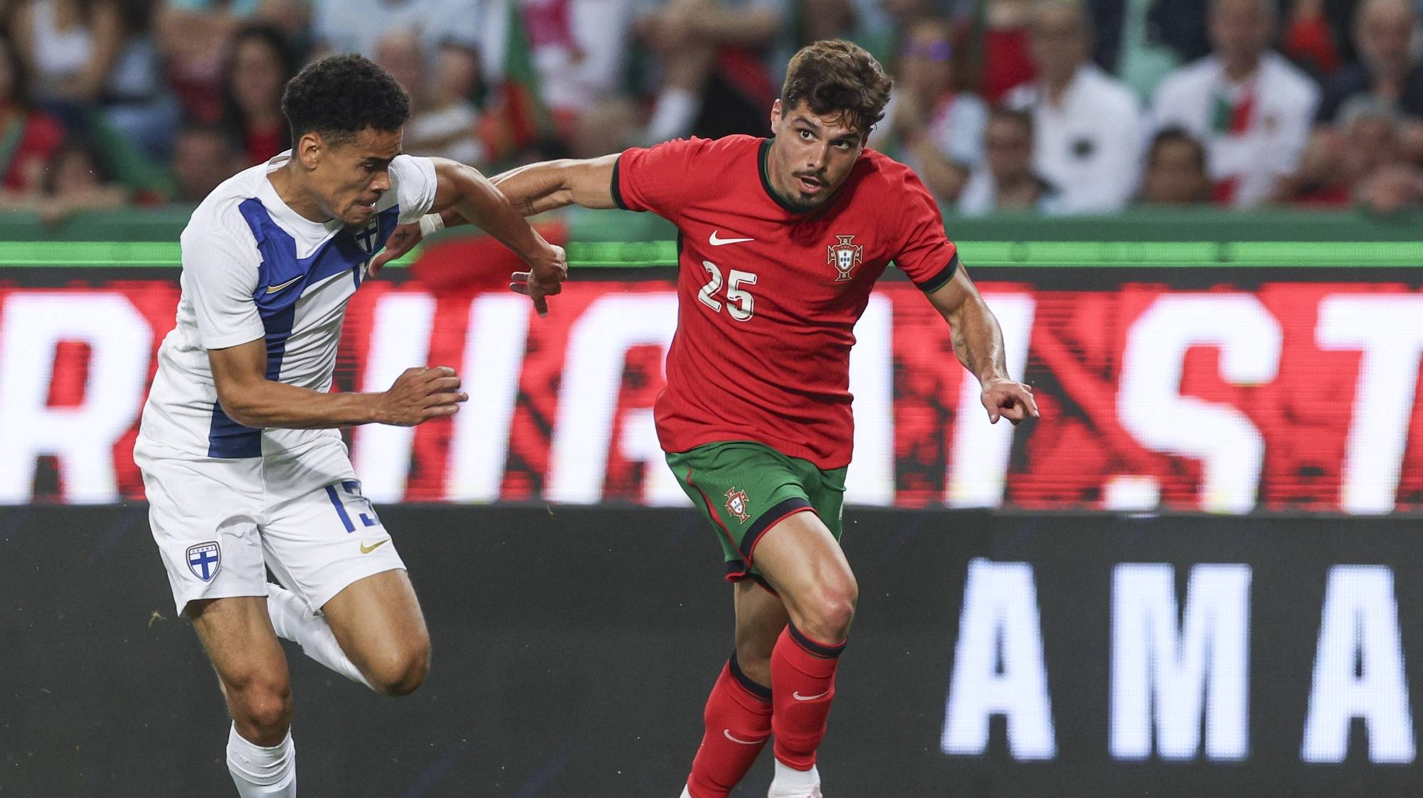 epa11390146 Portugal player Pedro Neto (R) in action with Finland`s Pyry Soiri during the international friendly soccer match between Portugal and Finland, in Lisbon, Portugal, 04 June 2024.  EPA/MIGUEL A. LOPES