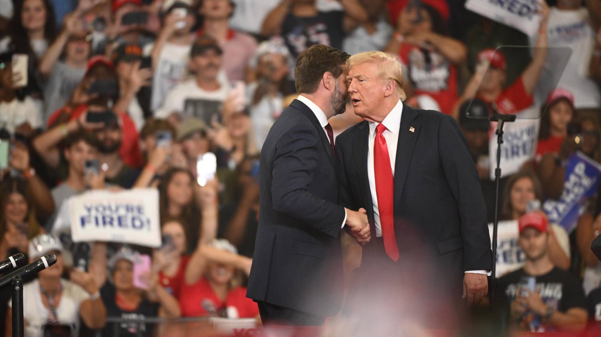 epa11523819 Republican presidential candidate Donald J. Trump (R) and Republican vice presidential candidate Senator JD Vance (L) of Ohio appear on stage during a campaign rally at the Georgia State Convocation Center in Atlanta, Georgia, USA, 03 August 2024.  EPA/EDWARD M. PIO RODA