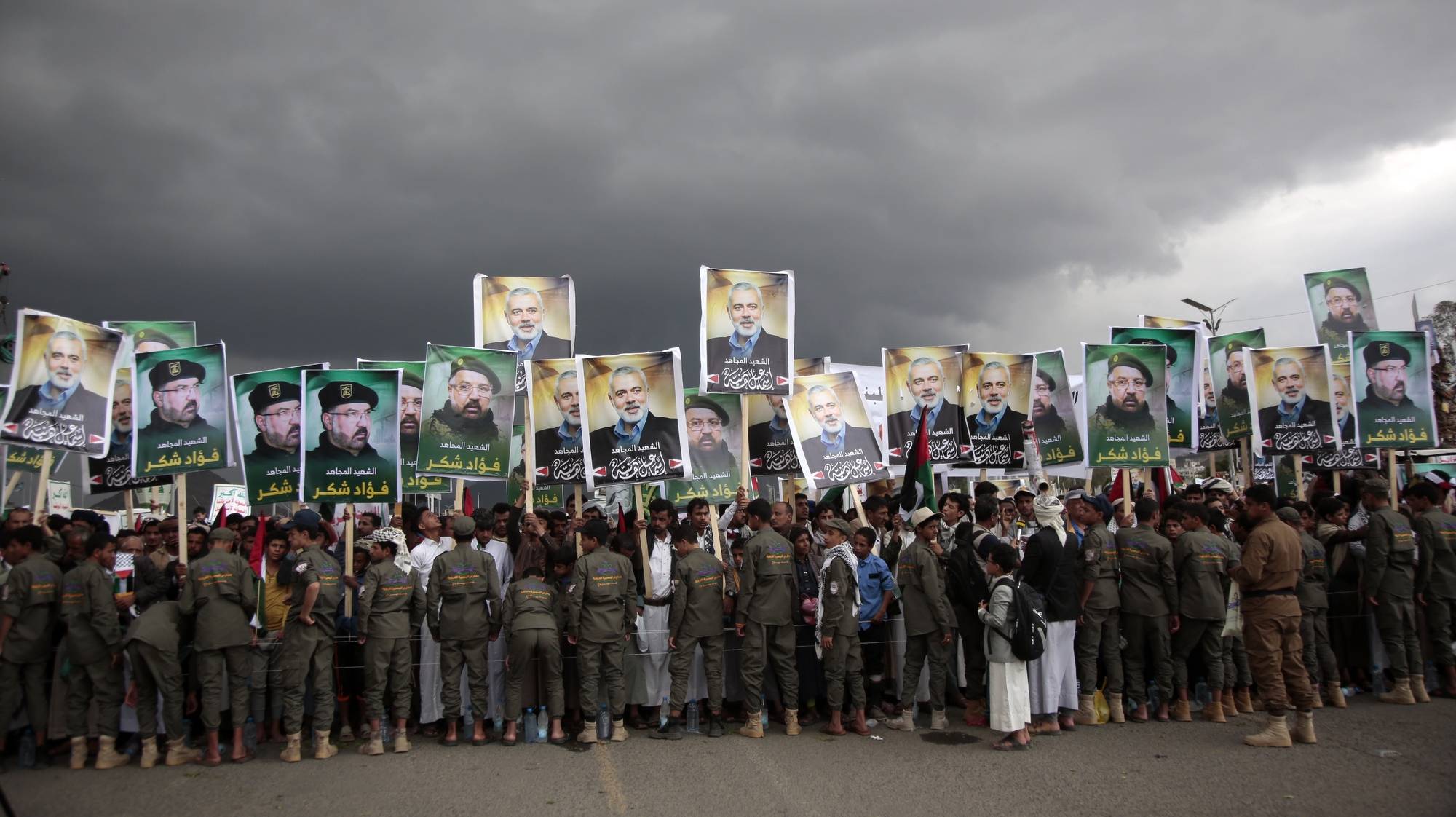 epa11519639 Houthi supporters hold placards with pictures of late Hamas political leader Ismail Haniyeh and Hezbollah senior commander Fuad Shukr during a protest following their deaths, in Sana&#039;a, Yemen, 02 August 2024. According to an Iranian Revolutionary Guard Corps (IRGC) statement on 31 July, Hamas political leader Ismail Haniyeh and one of his bodyguards were targeted and killed in Tehran, Iran, on 31 July 2024. Hezbollah and the Israel Defense Forces (IDF) confirmed that Hezbollah senior commander Fuad Shukr was killed in an Israeli strike on 30 July in the Haret Hreik neighborhood of Beirut.  EPA/OSAMAH YAHYA