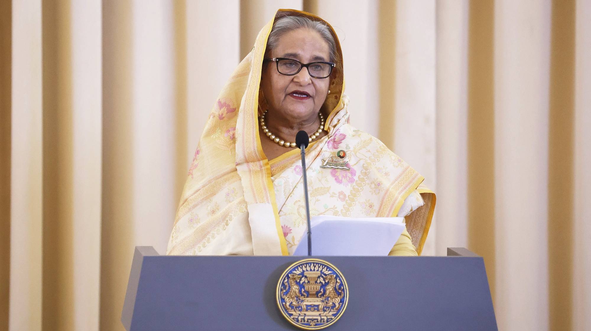 epa11526981 (FILE) Bangladesh Prime Minister Sheikh Hasina delivers a joint statement at the Government House in Bangkok, Thailand, 26 April 2024 (reissued 05 August 2024). Dhaka authorities have imposed a new curfew starting 06:00 p.m. local time on 04 August. As casualties mounted and law enforcement struggled to contain the unrest, the Bangladeshi government on 20 July 2024 had imposed an initial nationwide curfew and deployed military forces after violence broke out in Dhaka and other regions following student-led protests demanding reforms to the government&#039;s job quota system.  EPA/NARONG SANGNAK