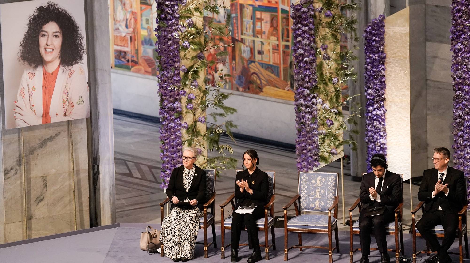 epa11021053 (L-R) Nobel committee chair Berit Reiss-Andersen, Kiana and Ali Rahmani attend the awarding of the Nobel Peace Prize for 2023 in Oslo City Hall, Norway, 10 December 2023. Iranian human rights activist and Nobel Peace Prize 2023 winner, Narges Mohammadi, is imprisoned and is therefore represented by her children Ali and Kiana Rahmani and husband Taghi Rahmani. Mohammadi receives the peace prize for her fight against the oppression of women in Iran and the fight for human rights and freedom for all.  EPA/FREDRIK VARFJELL  NORWAY OUT