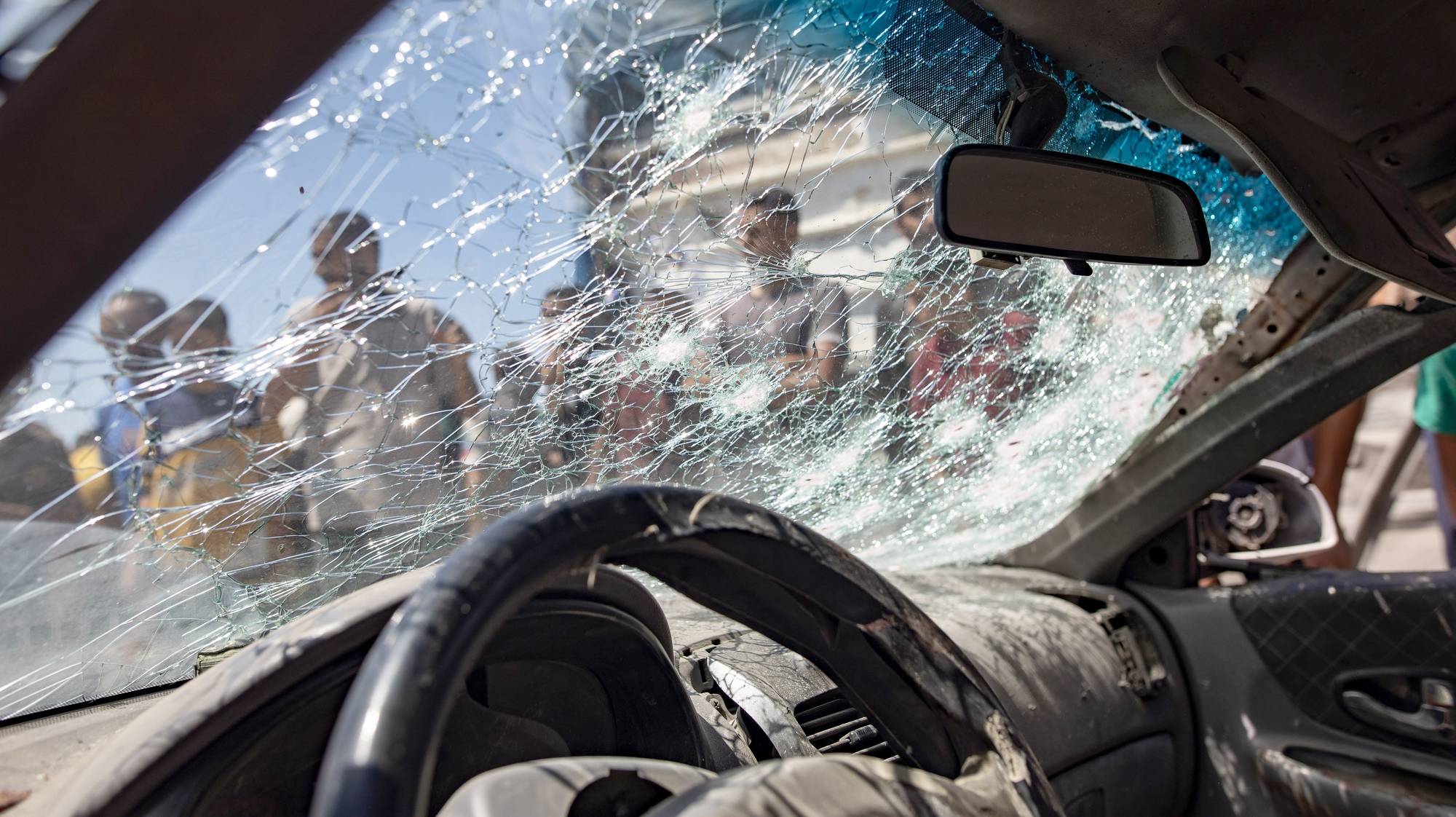 epa11481676 Palestinians inspect a damaged car after an Israeli air strike in the Al-Mawasi area of  Khan Yunis, southern Gaza Strip, 16 July 2024. At least 20 Palestinians have been killed after an Israeli military strike hit near tents of displaced people in the Al-Mawasi area of Khan Yunis, according to the Palestinian Ministry of Health. More than 38,000 Palestinians and over 1,400 Israelis have been killed, according to the Palestinian Health Ministry and the Israel Defense Forces (IDF), since Hamas militants launched an attack against Israel from the Gaza Strip on 07 October 2023, and the Israeli operations in Gaza and the West Bank which followed it.  EPA/HAITHAM IMAD