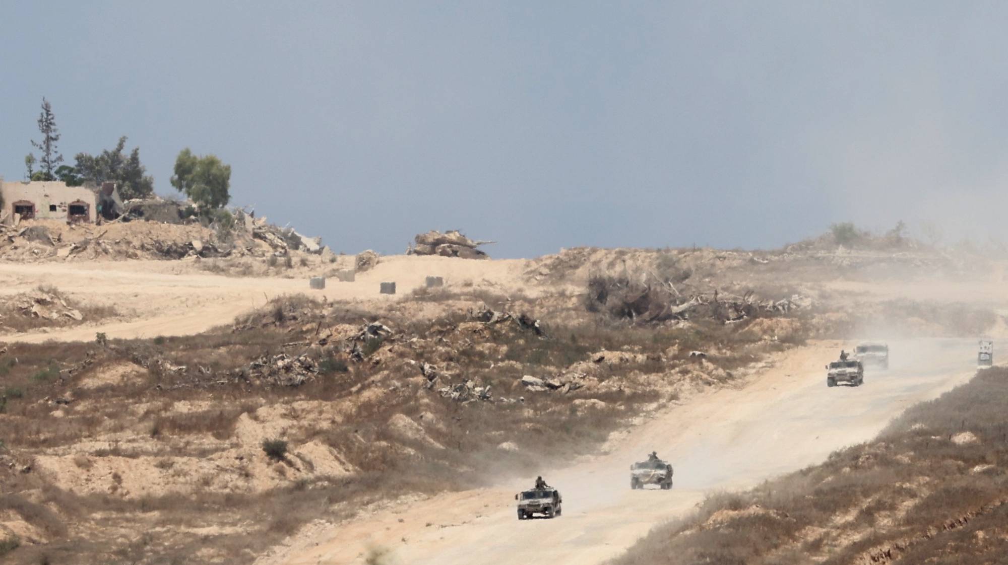 epa11472146 Israeli army vehicles patrol inside Gaza as seen from the Israeli side of the border with the Gaza Strip, southern Israel, 11 July 2024. More than 37,000 Palestinians and over 1,400 Israelis have been killed, according to the Palestinian Health Ministry and the Israel Defense Forces (IDF), since Hamas militants launched an attack against Israel from the Gaza Strip on 07 October 2023, and the Israeli operations in Gaza and the West Bank which followed it.  EPA/ABIR SULTAN