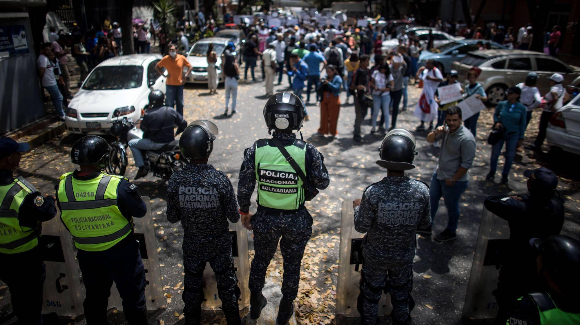 epa10509881 Venezuelan National Police forces stand guard as women demonstrate during the commemoration of International Women&#039;s Day, in Caracas, Venezuela, 08 March 2023. Some 300 women protested in Caracas, on the occasion of International Women&#039;s Day, to demand compliance with their labor rights, as well as improvements in regulations that cover issues such as gender violence or sexual and reproductive health, among others.  EPA/MIGUEL GUTIERREZ