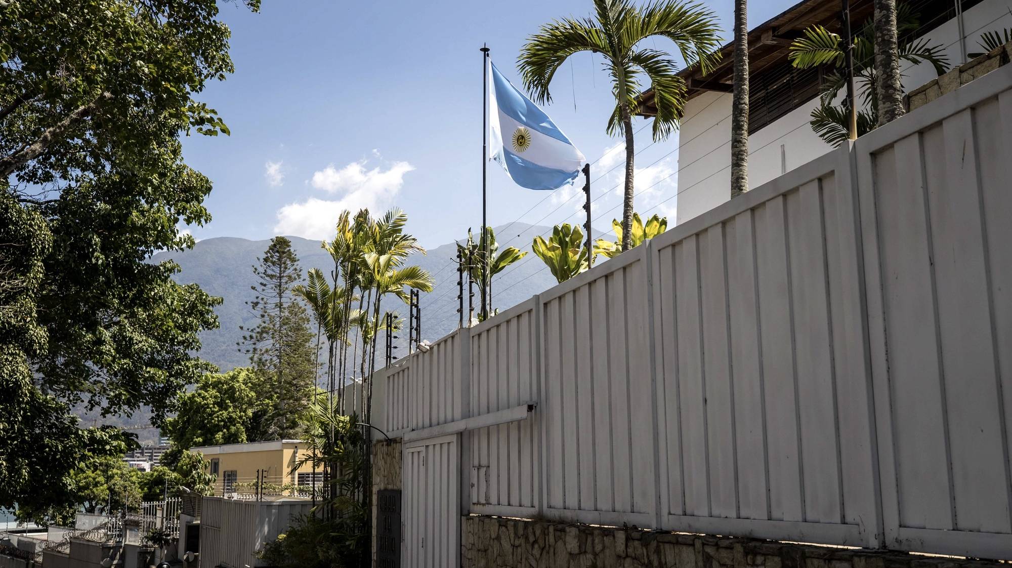 epa11247097 People pass the Argentine embassy headquarters in Caracas, Venezuela, 27 March 2024. A task force of Nicolas Maduro&#039;s government cut off the electricity supply to the Argentine embassy&#039;s headquarters, where several Venezuelan opposition leaders have taken shelter. The incident was confirmed and denounced by the Argentine government in a statement issued by the President&#039;s Office on 27 March.  EPA/MIGUEL GUTIERREZ