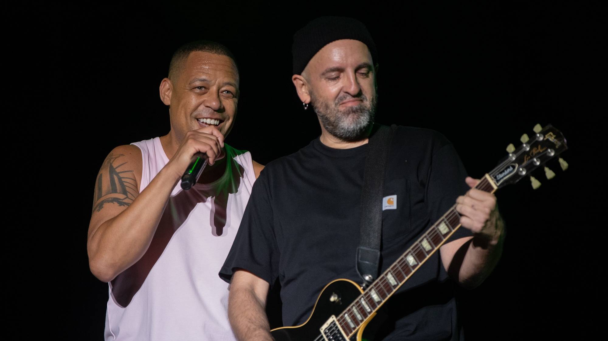 epa10747016 Portuguese singer Carlao (L) and guitarist Guillaz of Da Weasel perform live in concert on the first day of the Mares Vivas Festival in Madalena, Vila Nova de Gaia, Portugal, 14 July 2023. The festival  runs until 16 July.  EPA/RUI FARINHA