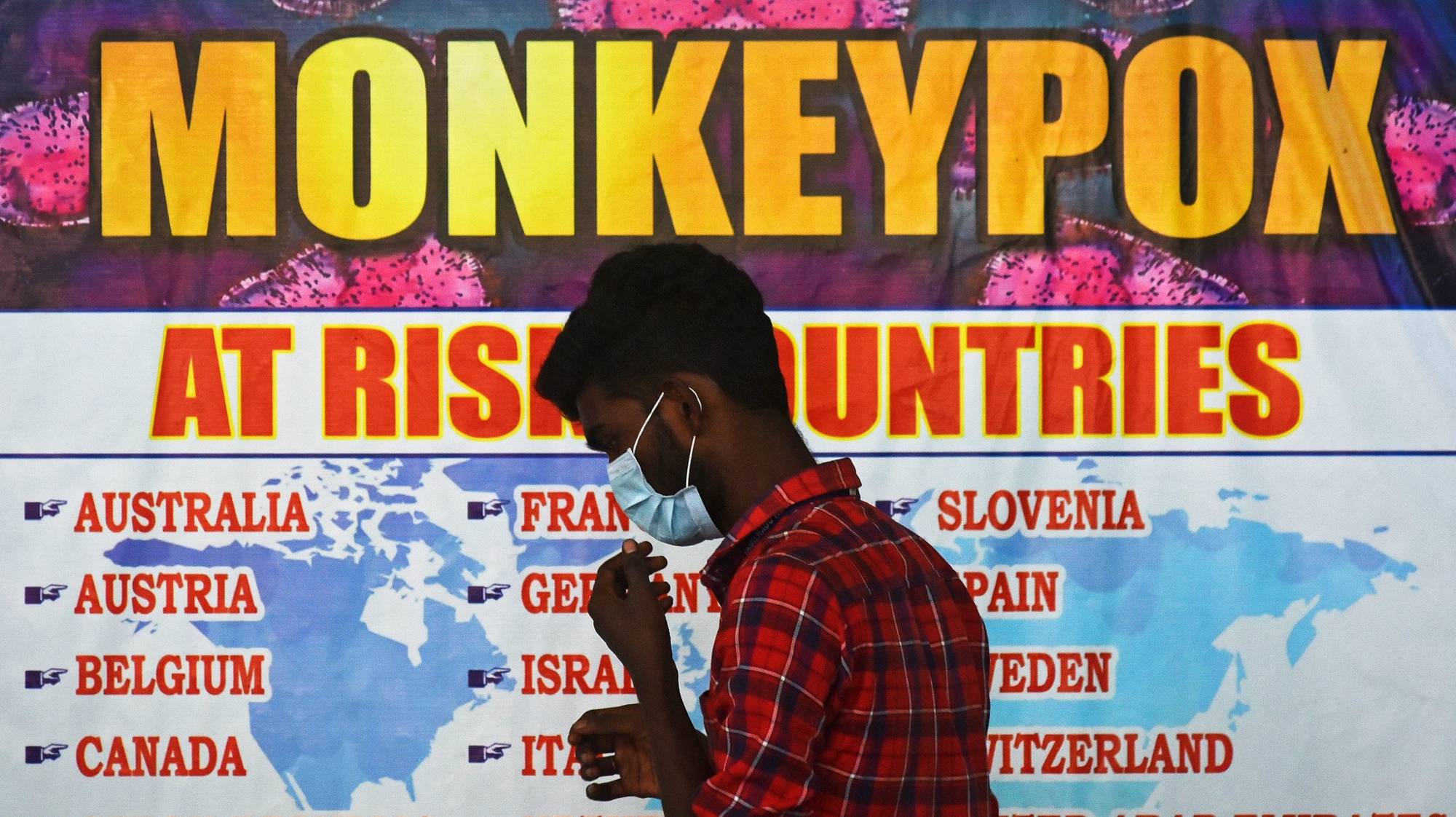 epa10334196 (FILE) - An Indian health worker walks in front of a list of high-risk countries for the Monkeypox virus, at Chennai International Airport, in Chennai, India, 16 July 2022 (reissued 28 November 2022). The World Health Organization (WHO) in a statement on 28 November 2022 said it &quot;will begin using a new preferred term mpox as a synonym for monkeypox&quot; simultaneously for one year until the term &#039;monkeypox&#039; is phased out. The decsion was taken after consultations with global experts as &quot;racist and stigmatizing language online, in other settings and in some communities was observed and reported to WHO.&quot;  EPA/IDREES MOHAMMED