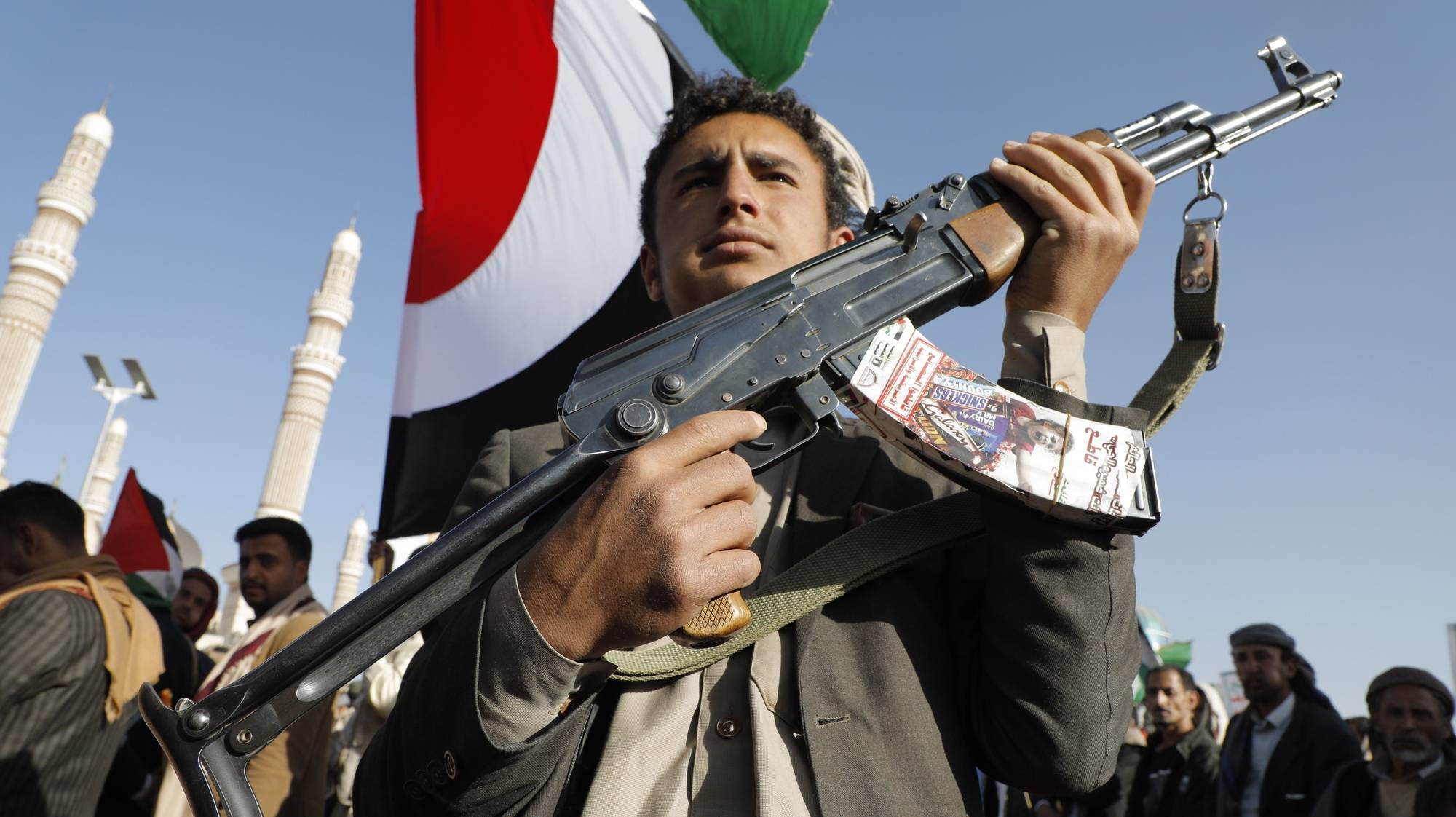 epaselect epa11041163 A man holds a gun during a protest against the recently announced operation to safeguard trade and to protect ships in the Red Sea, in Sana&#039;a, Yemen, 22 December 2023. Thousands of people gathered at a square in the Houthis-controlled Sana&#039;a to protest against the coalition created recently by the United States and denounce the Israeli strikes on the Gaza Strip. On 18 December, the US Department of Defense announced a multinational operation to safeguard trade and to protect ships in the Red Sea amid the recent escalation in Houthi attacks originating from Yemen, according to a press release from the US Department of Defense. Thousands of Israelis and Palestinians have died since the militant group Hamas launched an unprecedented attack on Israel from the Gaza Strip on 07 October, and the Israeli strikes on the Palestinian enclave which followed it.  EPA/OSAMAH YAHYA