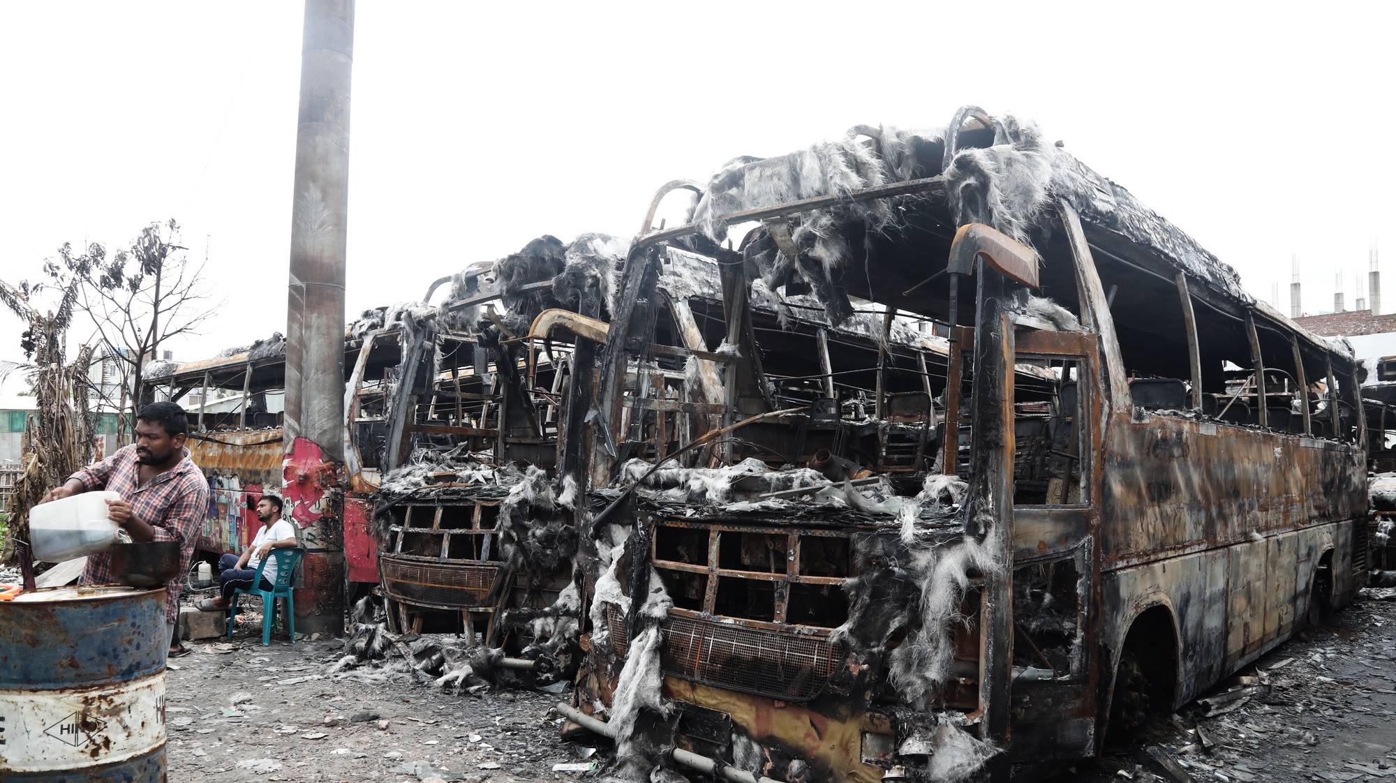 epa11492258 Charred buses at a bus depot in Dhaka, Bangladesh, 23 July 2024. The Bangladeshi government imposed a nationwide curfew and deployed military forces after violence broke out in Dhaka and other regions following student-led protests demanding reforms to the government&#039;s job quota system.  EPA/MONIRUL ALAM