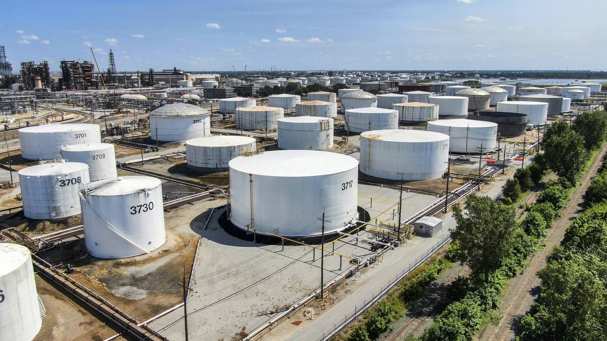 epa07803126 An aerial view taken with a drone shows oil storage tanks at the BP oil refinery in Whiting, Indiana, USA, 29 August 2019. The facility has the capability of handling 400,000 barrels of crude oil per day and it is the sixth largest oil refinery in the USA. Standard Oil of Indiana first established the refinery in 1889.  EPA/TANNEN MAURY