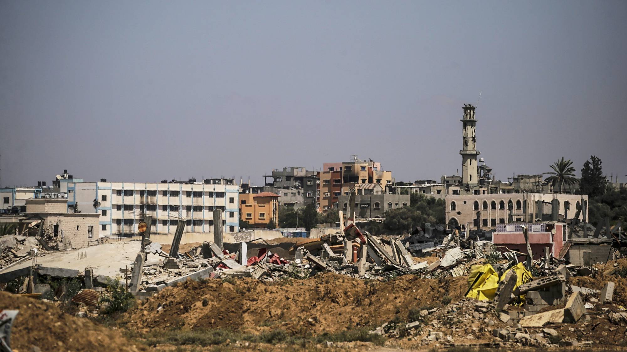 epa11506160 Destroyed structures as Palestinians flee from Al Bureije refugee camp after a new evacuation order was issued by the Israel Defense Forces (IDF) for Al Bureije and Al Nusairat camps in the central Gaza Strip, 29 July 2024. More than 39,000 Palestinians and over 1,400 Israelis have been killed, according to the Palestinian Health Ministry and the Israel Defense Forces (IDF), since Hamas militants launched an attack against Israel from the Gaza Strip on 07 October 2023, and the Israeli operations in Gaza and the West Bank which followed it.  EPA/MOHAMMED SABER