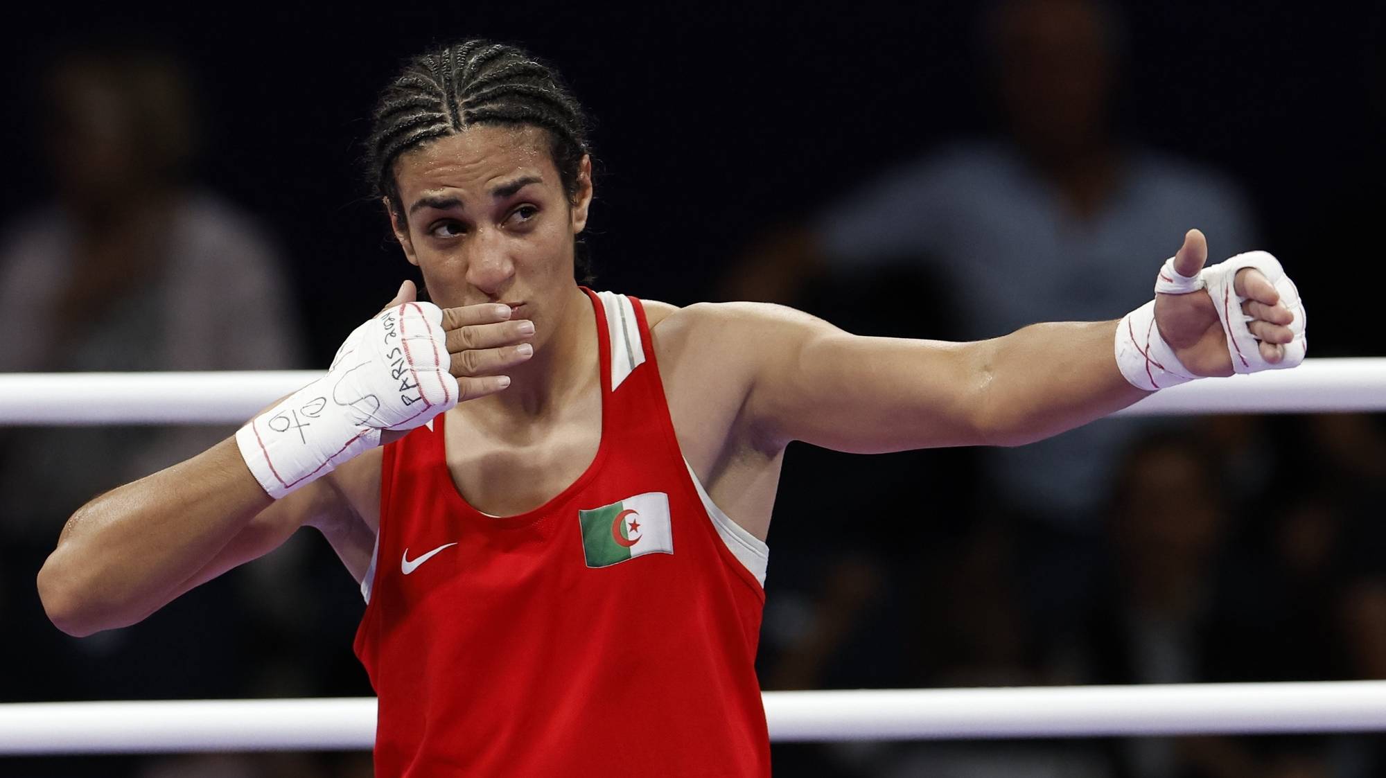 epa11522799 Imane Khelif of Algeria (red) celebrates winning over Anna Luca Hamori of Hungary (blue) in their Women 66kg Quarterfinal bout of the Boxing competitions in the Paris 2024 Olympic Games, at the North Paris Arena in Villepinte, France, 03 August 2024.  EPA/Miguel Tona