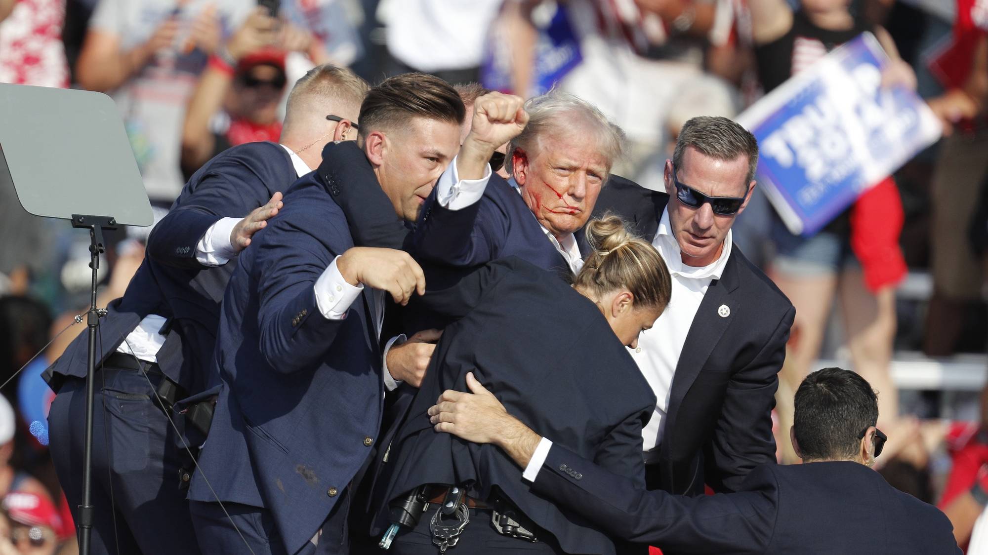 epa11476746 Former US President Donald Trump is rushed off stage by secret service after an incident during a campaign rally at the Butler Farm Show Inc. in Butler, Pennsylvania, USA, 13 July 2024.  EPA/DAVID MAXWELL