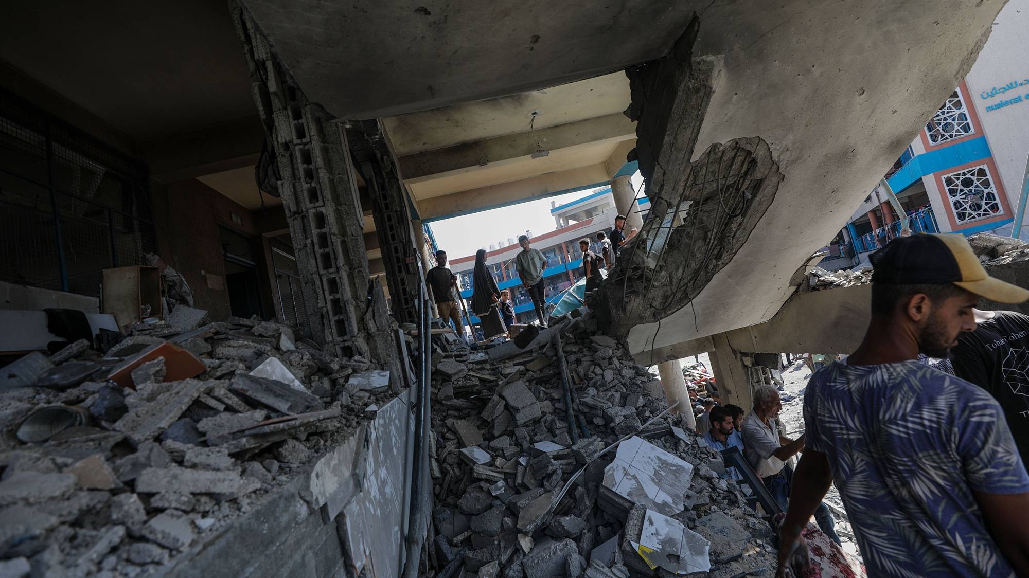 epa11478181 Palestinians inspect a damaged UNRWA school following an Israeli air strike in Al Nuseirat refugee camp, central Gaza Strip, 14 July 2024. At least 12 people were killed following an Israeli air strike in the camp, according to the Palestinian Ministry of Health. The Israeli military stated on 14 July, that the Israeli Air Force (IAF) struck the area of UNRWA&#039;s Abu Oraiban School School building in Nuseirat, claiming that the location served as a &#039;hideout and operational infrastructure&#039; to direct and carry attacks against Israeli troops operating in the Gaza Strip. More than 38,000 Palestinians and over 1,400 Israelis have been killed, according to the Palestinian Health Ministry and the Israel Defense Forces (IDF), since Hamas militants launched an attack against Israel from the Gaza Strip on 07 October 2023, and the Israeli operations in Gaza and the West Bank which followed it.  EPA/MOHAMMED SABER