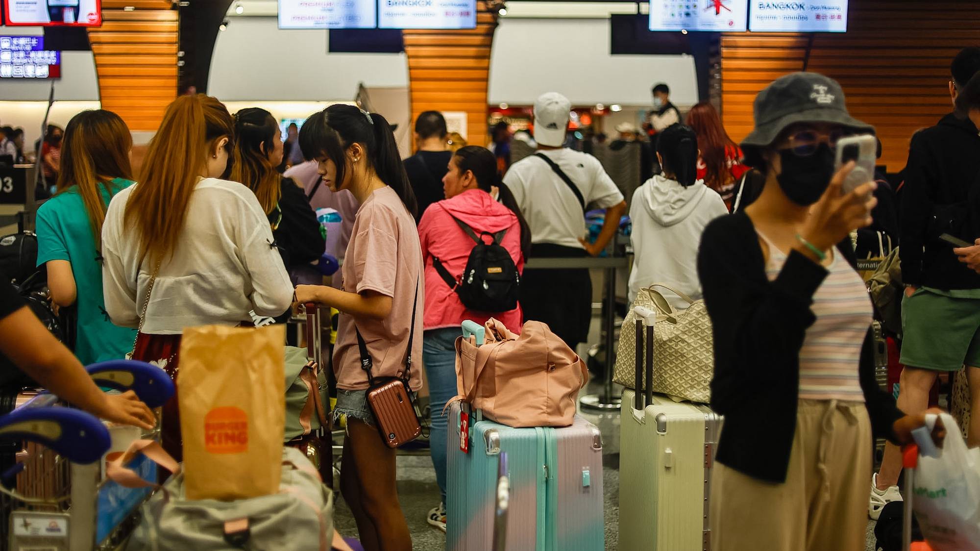 epa11495349 Travellers queue for departure check-in after multiple international flights have been cancelled or delayed, at Taoyuan International Airport, in Taoyuan, Taiwan, 25 July 2024. As of 16:30 on 25 July local time has typhoon Garmin taken at least three lives, injured more than 200 people and damaged structures all over Taiwan, according to the Central Emergency Operations Center. With domestic and international flights cancelled and trains services suspended it is the strongest tropical storm in eight years.  EPA/DANIEL CENG