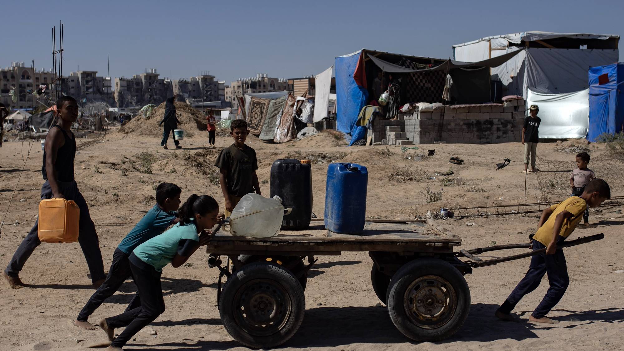 epa11455944 Children move a cart with containers as displaced Palestinians collect drinking water from a water tanker at a makeshift camp in the Khan Yunis refugee camp in the southern Gaza Strip, 03 July 2024. Since 07 October 2023, up to 1.7 million people, or more than 75 percent of the population, have been displaced throughout the Gaza Strip, some more than once, in search of safety, according to the United Nations Relief and Works Agency for Palestine Refugees in the Near East (UNRWA), which added that the Palestinian enclave is &#039;on the brink of famine&#039;, with 1.1 million people (half of its population) &#039;experiencing catastrophic food insecurity&#039; due to the conflict and restrictions on humanitarian access.  EPA/HAITHAM IMAD