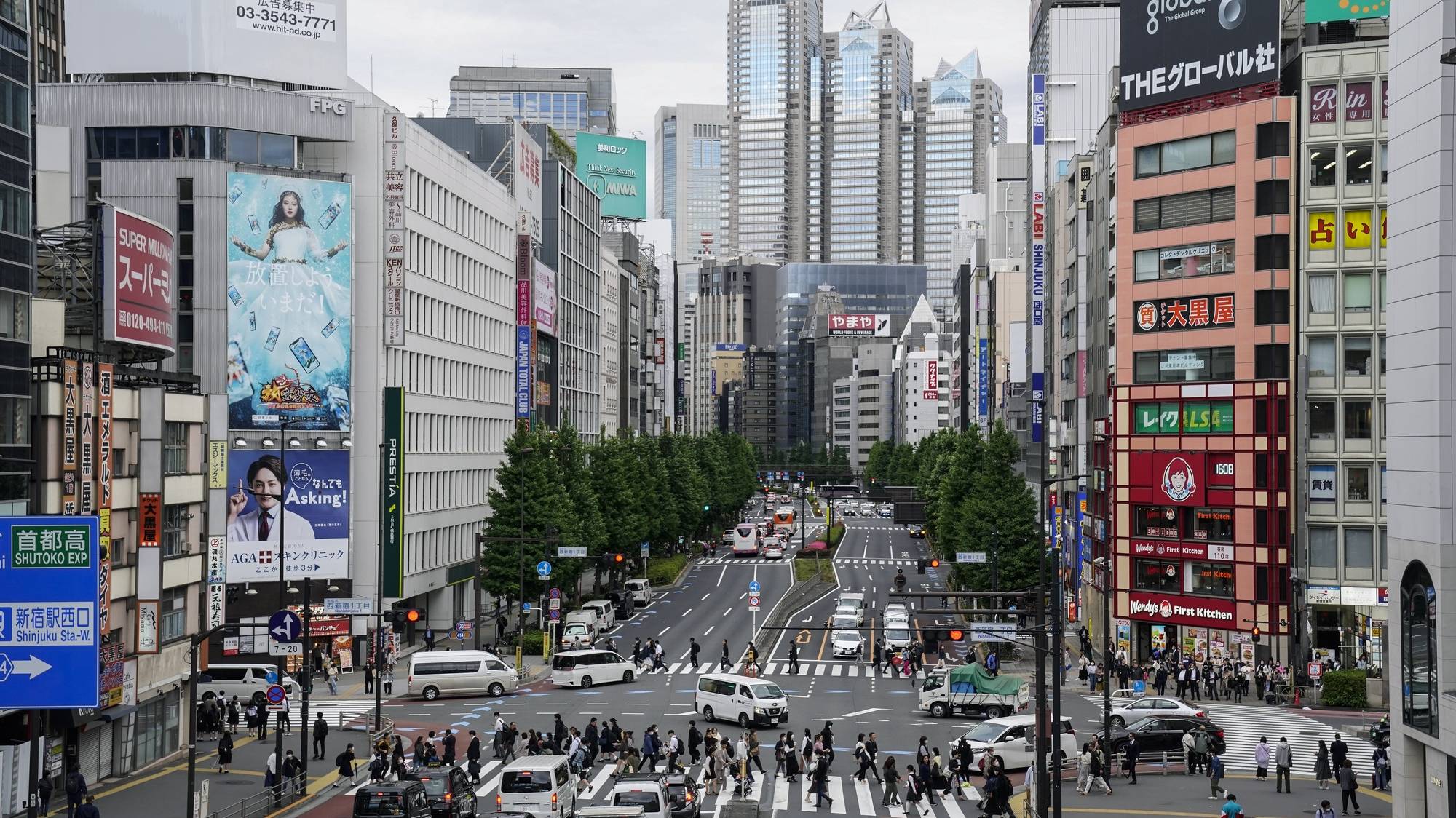 epa10615188 Pedestrians walk on crosswalk at Shinjuku in Tokyo, Japan, 08 May 2023. Japan downgraded the classification of COVID-19 disease from category II to V, the same as influenza, in the Japanese Infectious Disease Law on 08 May 2023, to lift restrictions after the World Health Organization (WHO) declared the end to the COVID-19 international health emergency phase on 05 May. It is expected to improve the Japanese economy.  EPA/KIMIMASA MAYAMA