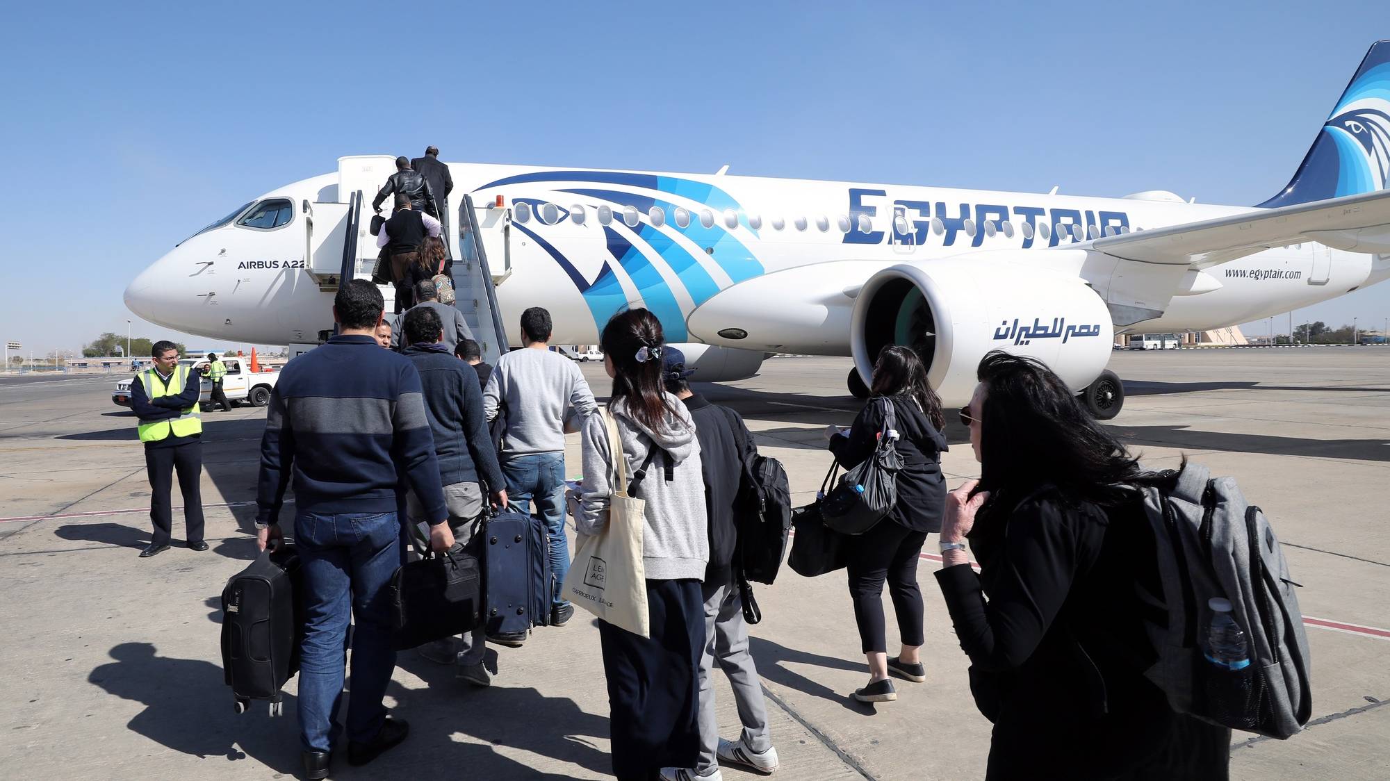 epa08297880 (FILE) - Passengers board an EgyptAir Airbus A220 from Aswan Airport, in Aswan, south Egypt, 13 February 2020 (reissued 16 March 2020). According to reports, Egypt on 16 March announced that all international flights will be suspended from 19 till 31 March over coronavirus concerns.  EPA/KHALED ELFIQI *** Local Caption *** 55872070