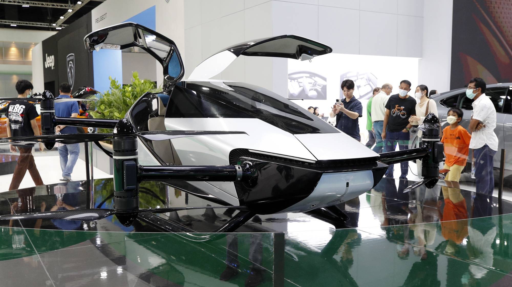 epa11247988 Visitors view Chinese automaker XPENG&#039;s X2 flying car displayed at the 45th Bangkok International Motor Show 2024 in Nonthaburi province on the outskirts of Bangkok, Thailand, 28 March 2024. More than 49 leading brands of the world&#039;s major automakers attend to exhibit and unveil their automotive products and technology including the new electric vehicles, in the annual automobile showcase amid Thailand&#039;s sluggish domestic car sales continuing to decline to the lowest level in two years by 26 percent year-on-year in February 2024, according to the Federation of Thai Industries.  EPA/RUNGROJ YONGRIT