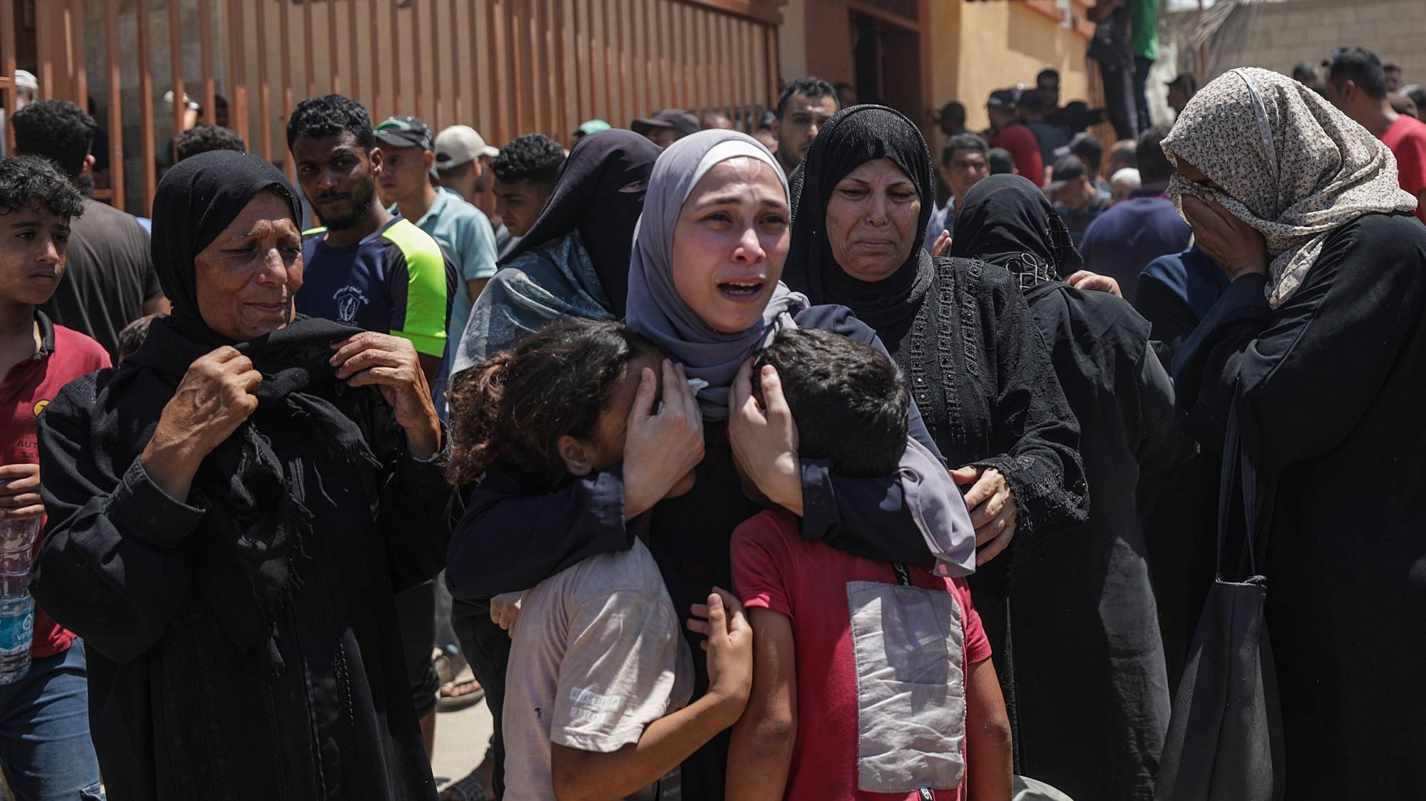 epaselect epa11476047 A Palestinian woman (C) reacts with her children as she mourns after her husband was killed following an Israeli air strike in the Al-Mawasi area of Khan Yunis, southern Gaza Strip, 13 July 2024. At least 71 Palestinians have been killed and 289 others injured after an Israeli military strike hit near tents of displaced people in the Al-Mawasi area of Khan Yunis, according to the Palestinian Ministry of Health. The Israeli military stated on 13 July, it targeted senior Hamas leaders in the area of Khan Yunis. More than 38,000 Palestinians and over 1,455 Israelis have been killed, according to the Palestinian Health Ministry and the IDF, since Hamas militants launched an attack against Israel from the Gaza Strip on 07 October 2023, and the Israeli operations in Gaza and the West Bank which followed it.  EPA/MOHAMMED SABER