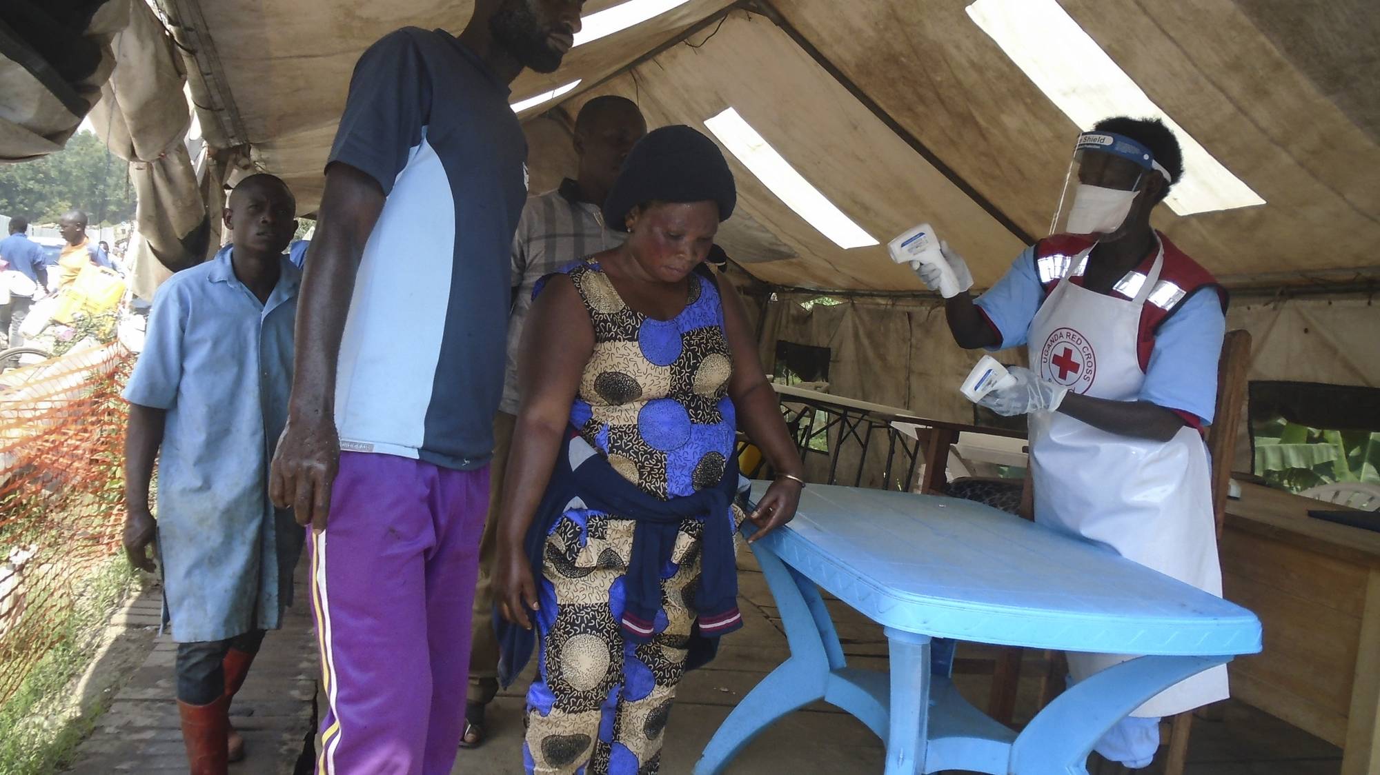 epa07803553 (FILE) - People are screened by Uganda Red Cross workers at the check point as they cross the border into Uganda from Democratic Republic of the Congo in the border town of Mpondwe in western Uganda, 14 June 2019 (reissued 30 August 2019). According to officials, a girl from entering Uganda from DR Congo has been diagnosed with ebola by a screening team at Mpondwe border crossing.  EPA/ENID NINSIIMA *** Local Caption *** 55272742