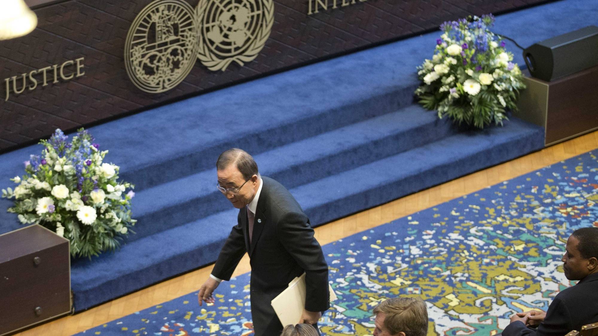 epa05268242 United Nations Secretary-General Ban Ki-moon passes Dutch King Willem-Alexander as he walks towards a lectern to deliver a speech during a ceremony marking the 70th anniversary of the International Court of Justice in The Hague, Netherlands, 20 April 2016. The Charter of the United Nations and the Statute of the International Court of Justice, which forms an integral part of the Charter, were signed in San Francisco on 26 June 1945 and came into  force on 24 October 1945. Its inaugural sitting took place on 18 April 1946.  EPA/PETER DEJONG / POOL