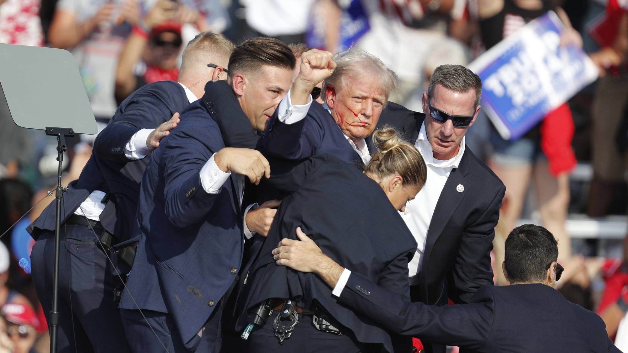 epa11476746 Former US President Donald Trump is rushed off stage by secret service after an incident during a campaign rally at the Butler Farm Show Inc. in Butler, Pennsylvania, USA, 13 July 2024.  EPA/DAVID MAXWELL