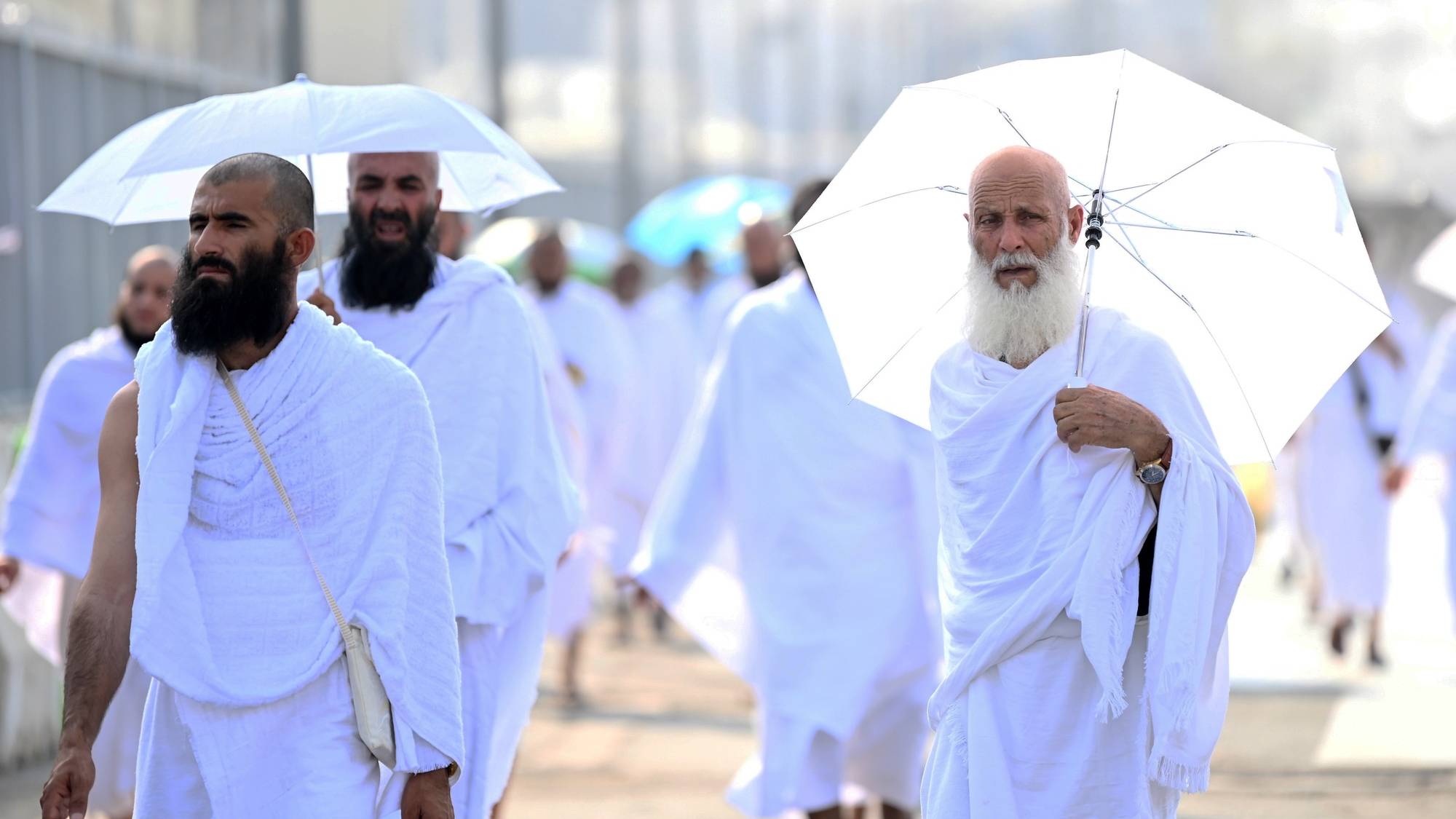 epa11409862 Muslim pilgrims make their way to the Mina tent camp for the start of the Hajj 2024 pilgrimage, in Mecca, Saudi Arabia, 14 June 2024. Pilgrims began arriving in Mina on 14 June for performing the Hajj 2024 rituals, taking place this year from the evening of 14 June until 19 June. Saudi authorities said that over 1.5 million pilgrims are expected in Saudi Arabia for this year&#039;s Hajj season. Muslims attending this year&#039;s Islamic Hajj pilgrimage will face the challenge of a significant rise in temperatures, which poses a threat to the health of pilgrims, according to the Ministry of Health statement, as the National Center for Meteorology (NCM) expected temperatures to range between 45 and 48 degrees Celsius at the holy sites.  EPA/STRINGER