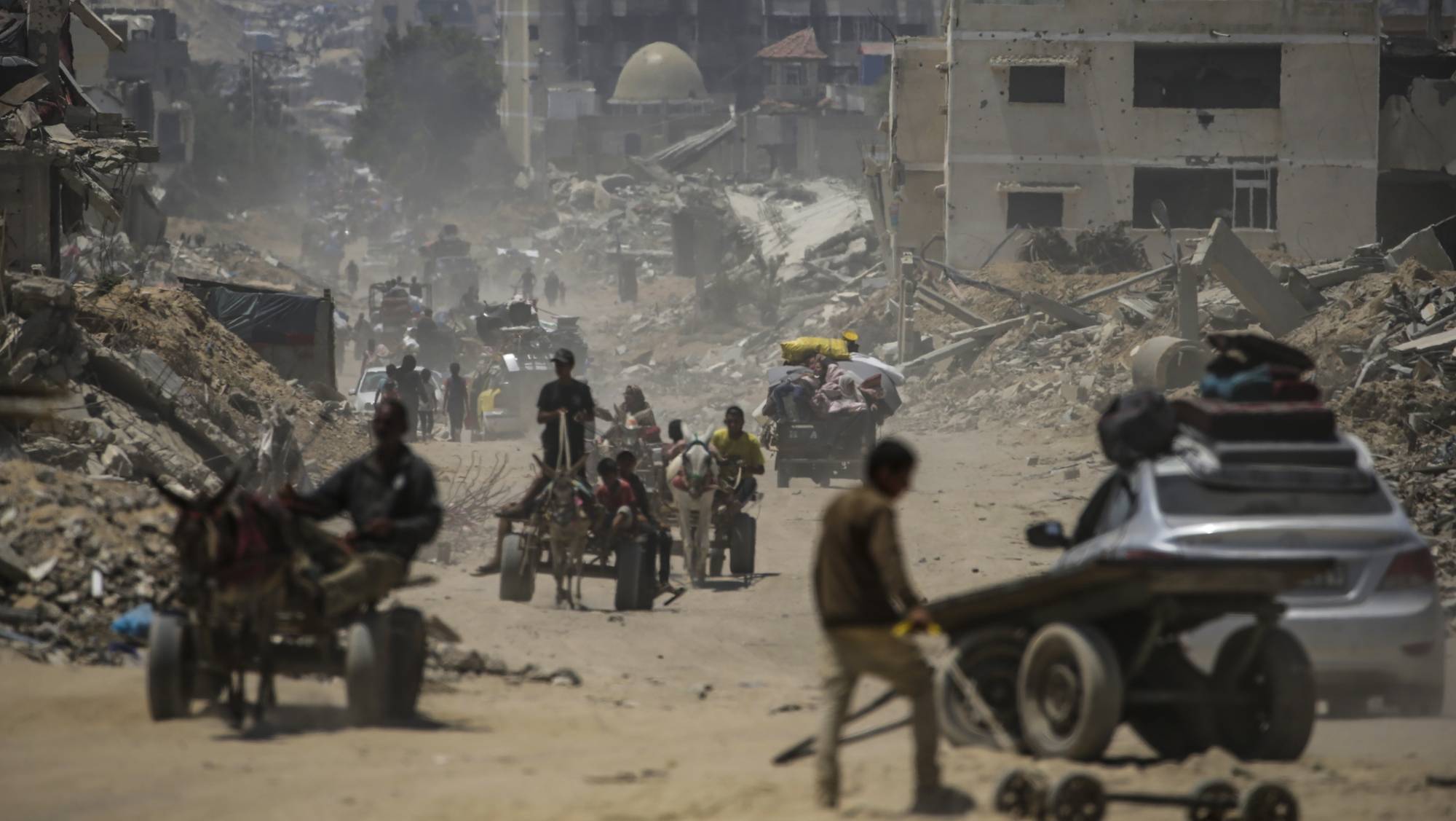 epaselect epa11453013 Internally displaced Palestinians leave with their belongings following an evacuation order issued by the Israeli army, in Khan Younis, southern Gaza Strip, 02 July 2024. More than 37,000 Palestinians and over 1,455 Israelis have been killed, according to the Palestinian Health Ministry and the IDF, since Hamas militants launched an attack against Israel from the Gaza Strip on 07 October 2023, and the Israeli operations in Gaza and the West Bank which followed it.  EPA/MOHAMMED SABER