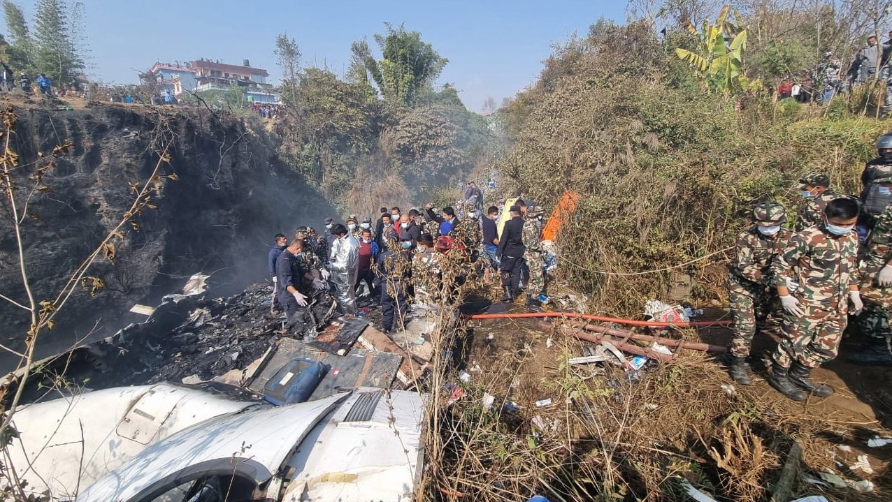epa10406241 Rescue teams work at the wreckage of a Yeti Airlines ATR72 aircraft after it crashed in Pokhara, Nepal, 15 January 2023. A Yeti Airlines ATR72 aircraft with 68 passengers and four crew members aboard crashed into a gorge after takeoff from the Pokhara International Airport. According to officials from the Nepal Civil Aviation Authority, 40 bodies have been recovered so far.  EPA/BIJAYA NEUPANE