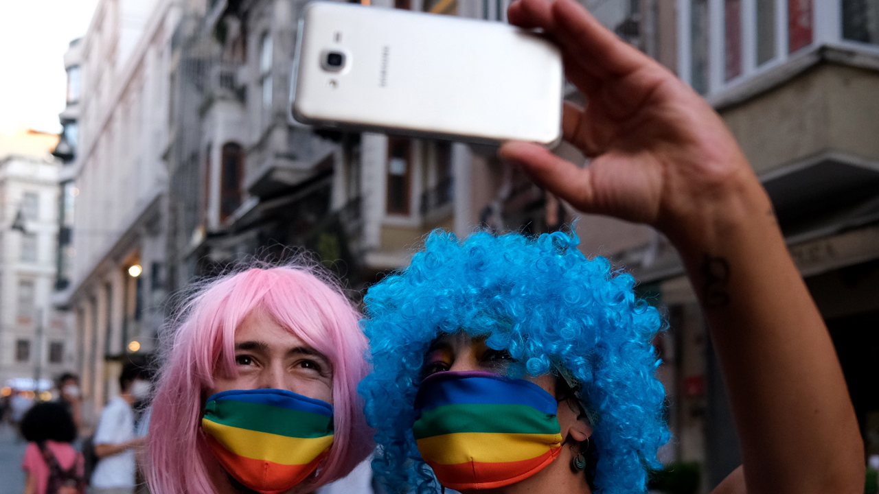 epa08514972 LGBTI (lesbian, gay, bisexual, transgender, and intersex) community members and supporters wear rainbow mask as they take selfie during the Global Pride in Istanbul, Turkey, 28 June 2020.  EPA/SEDAT SUNA