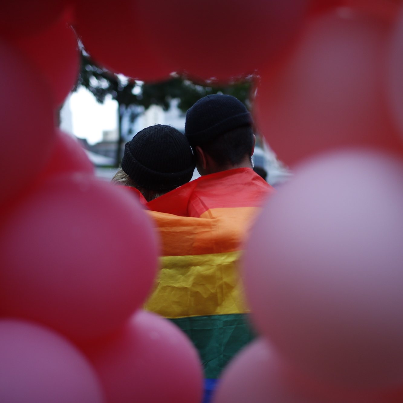 epa07683015 Seen through a balloon sculpture, a couple poses for a photograph with the rainbow flag draped over their shoulders during the Pink Dot event held at the Speaker&#039;s Corner in Hong Lim Park, Singapore, 29 June 2019. The annual Pink Dot event is the closest thing Singapore has to a gay pride parade which promotes an acceptance of the lesbian, gay, bisexual and transgender (LGBT) community and theme &#039;Standing Against Discrimination&#039;.  EPA/WALLACE WOON