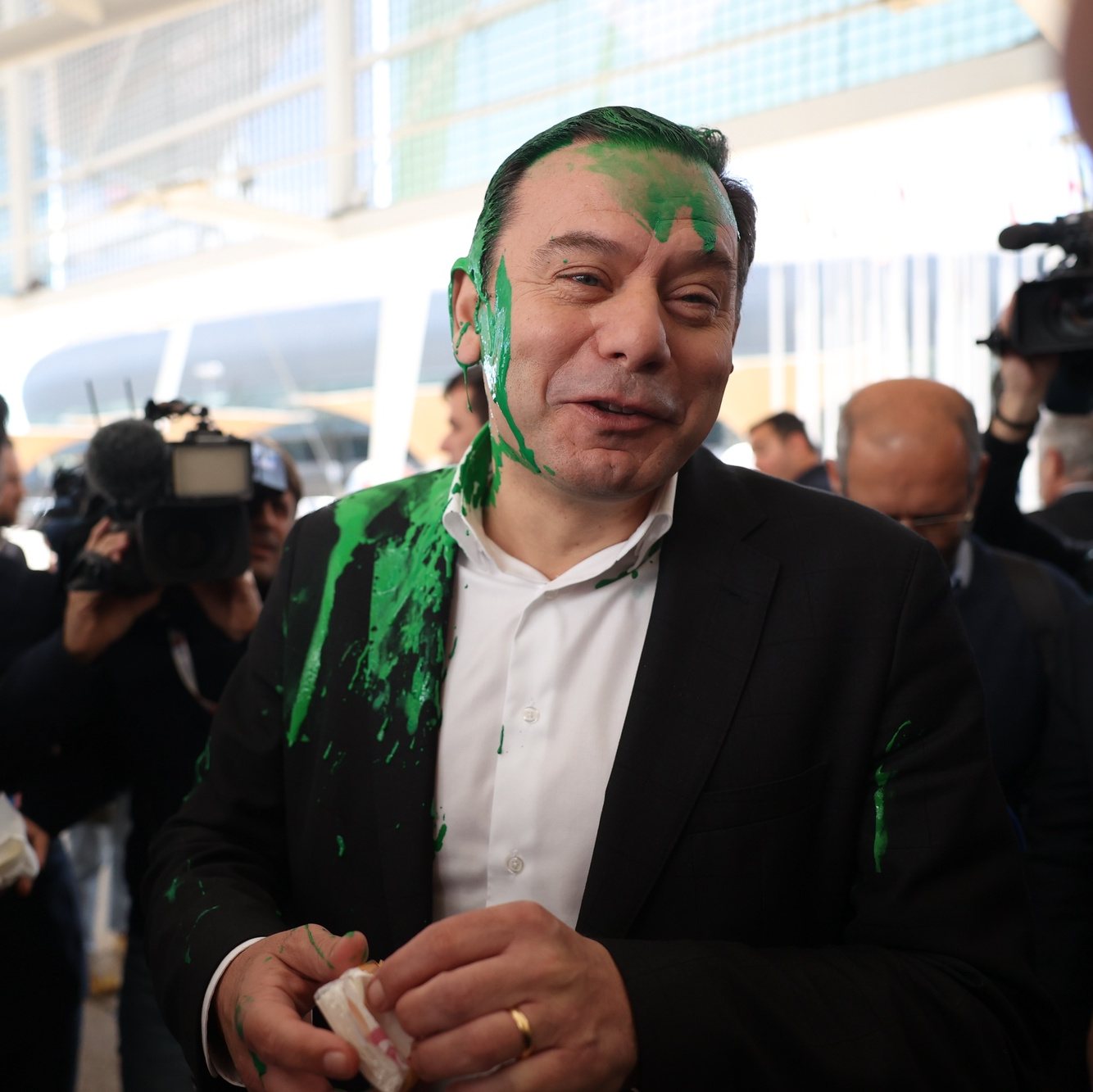 The president of the Democratic Social Party (PSD) Luis Montenegro (C) reacts after being hit with paint at his arrival at the Lisbon Tourism Fair (BTL) during a Democratic Alliance (AD) campaign, as part of the campaign for upcoming legislative elections, in Lisbon, Portugal, 28 February 2024. On January 15, the President of the Republic decreed the dissolution of parliament and the calling of early legislative elections on 10 March, following the resignation of Prime Minister Antonio Costa presented on 07 November 2023. ANDRE KOSTERS/LUSA