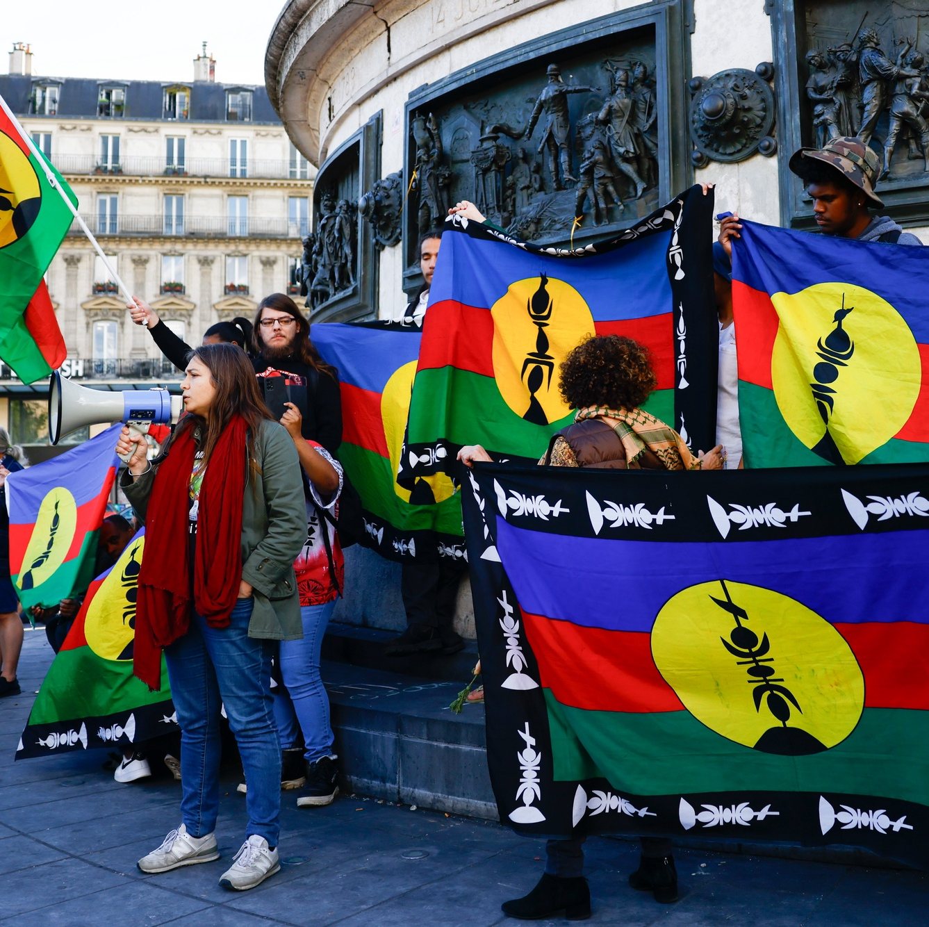 epa11346098 Protesters hold Kanak flags as they participate in a rally called by Caledonian activists in solidarity with Kanak people, at Place de la Republique in Paris, France, 16 May 2024. The French territory of New Caledonia has experienced three nights of clashes in response to a reform to electoral procedures, which the indigenous Kanak population believes will diminish their vote. France has declared a state of emergency and deployed its military to the territory&#039;s ports and international airport in response to the unrest, which has resulted in at least four deaths and hundreds of wounded.  EPA/MOHAMMED BADRA
