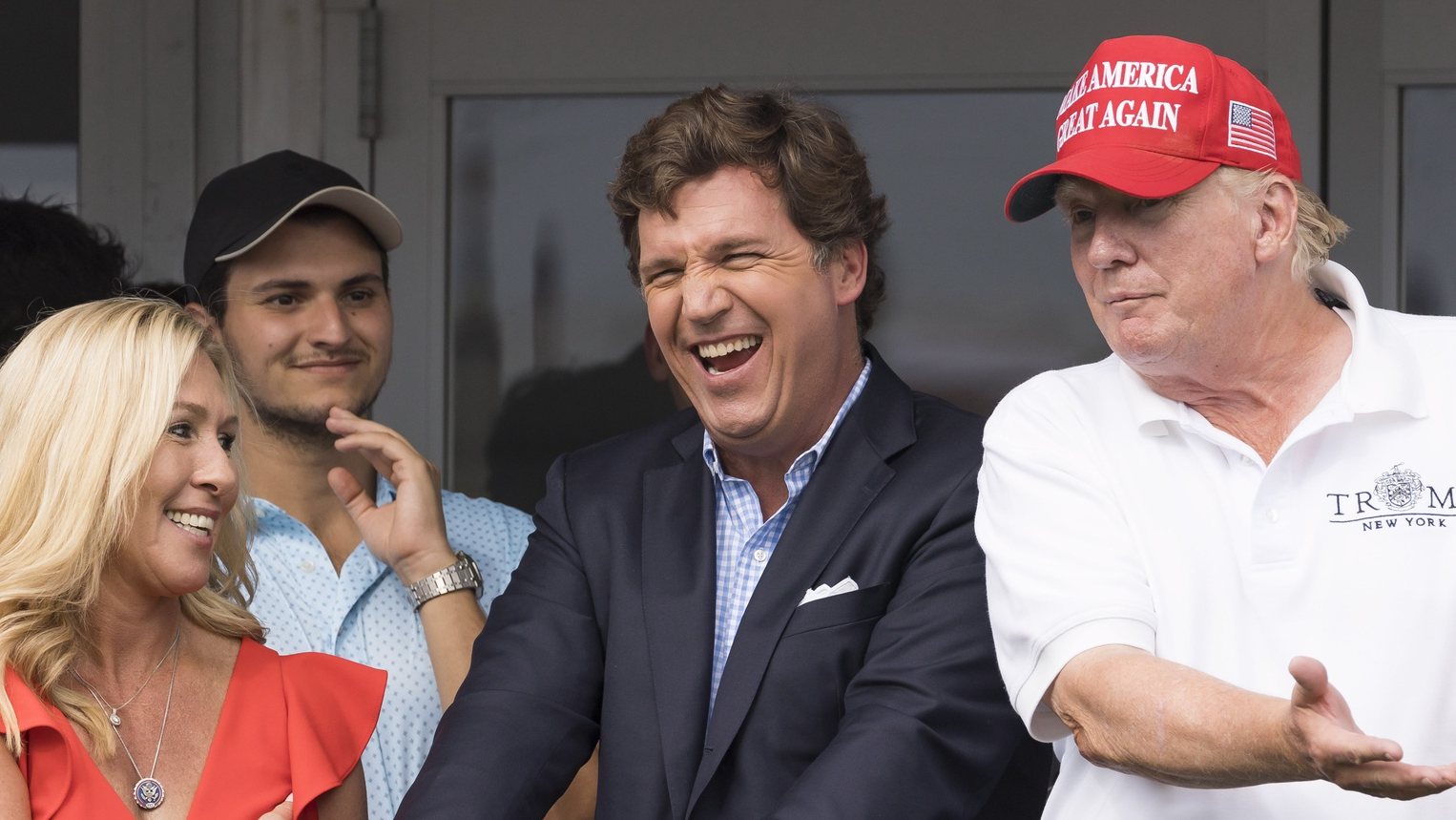 epaselect epa10100951 (L-R) Republican Congresswoman Majorie Taylor Greene of Georgia, Fox News television personality Tucker Carlson, and former US President Donald J. Trump watch the third round of the LIV Golf Bedminster invitational, part of the new LIV Golf Invitational Series, at the Trump National Golf Club in Bedminster, New Jersey, USA, 31 July 2022.  EPA/JUSTIN LANE