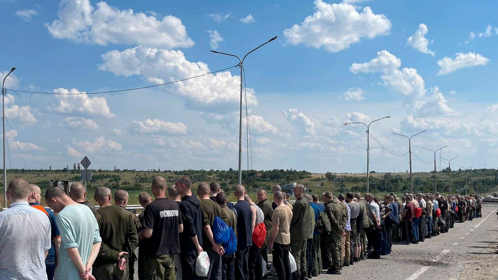 epa10042215 A handout picture made available by the press service of the Defense Intelligence of the Ministry of Defense of Ukraine, shows Ukrainian prisoners of war who were released as part of a prisoner swap with Russia, walking towards the Ukrainian side at an undisclosed location, Ukraine, 29 June 2022. The 144 Ukrainian soldiers were released from Russian captivity, 95 of them were part of the Azovstal (Mariupol) fighters. According to a statement by the Ukrainian Presidential Office on 06 June quoting President Zelensky, there may be more than 2,500 prisoners from the Azovstal plant being held captive by Russian forces.  EPA/Defense Intelligence Ministry of Defense of Ukraine HANDOUT EDITORIAL USE ONLY NO SALES HANDOUT EDITORIAL USE ONLY/NO SALES