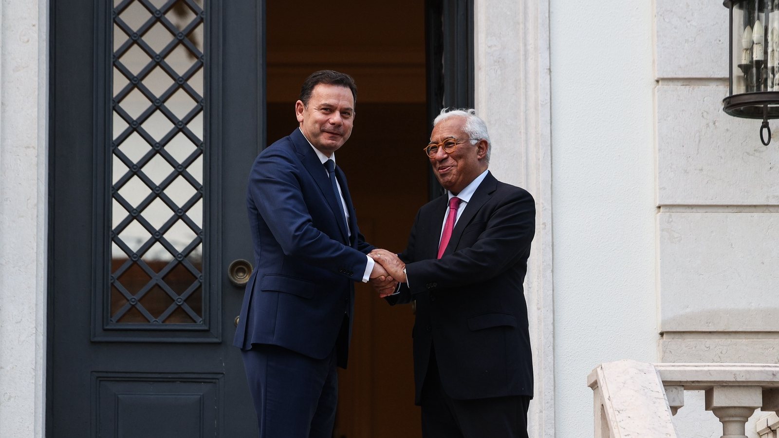 epa11247226 Portuguese Prime Minister-designate Luis Montenegro (L) is greeted by outgoing Prime Minister Antonio Costa upon his arrival for a meeting at the Sao Bento official residence in Lisbon, Portugal, 27 March 2024.  EPA/TIAGO PETINGA