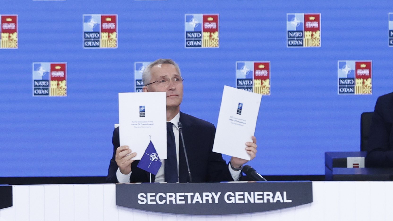 epa10042963 NATO&#039;s Secretary General, Jens Stoltenberg (C), holds the documents of the NATO Innovation Fund Letter of Commitment during the signing ceremony held in the framework of second and last day of NATO Summit at IFEMA Convention Center, in Madrid, Spain, 30 June 2022. Some 40 world leaders attend the summit, running from 29 to 30 June, focused on the ongoing Russian invasion of Ukraine. Spain hosts the event to mark the 40th anniversary of its accession to NATO.  EPA/BRAIS LORENZO