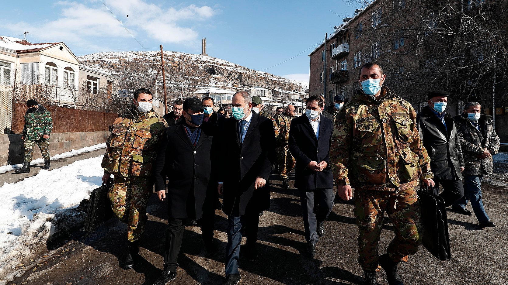 epa08897899 A handout photo made available by the press office of Armenian government shows Armenian Prime Minister Nikol Pashinyan (C) walks on a street in Sisian, Syunik region, Armenia, on the third day of the nationwide mourning 21 December 2020. Armenian Prime Minister Nikol Pashinyan declared a 3-day nationwide mourning period starting on December 19 for people who had been killed in the latest armed conflict between Azerbaijan and Armenia over the Nagorno-Karabakh territory along the contact line of the self-proclaimed Nagorno-Karabakh Republic (also known as Artsakh).  EPA/ARMENIAN GOVERNMENT PRESS OFFICE HANDOUT MANDATORY CREDIT HANDOUT EDITORIAL USE ONLY/NO SALES