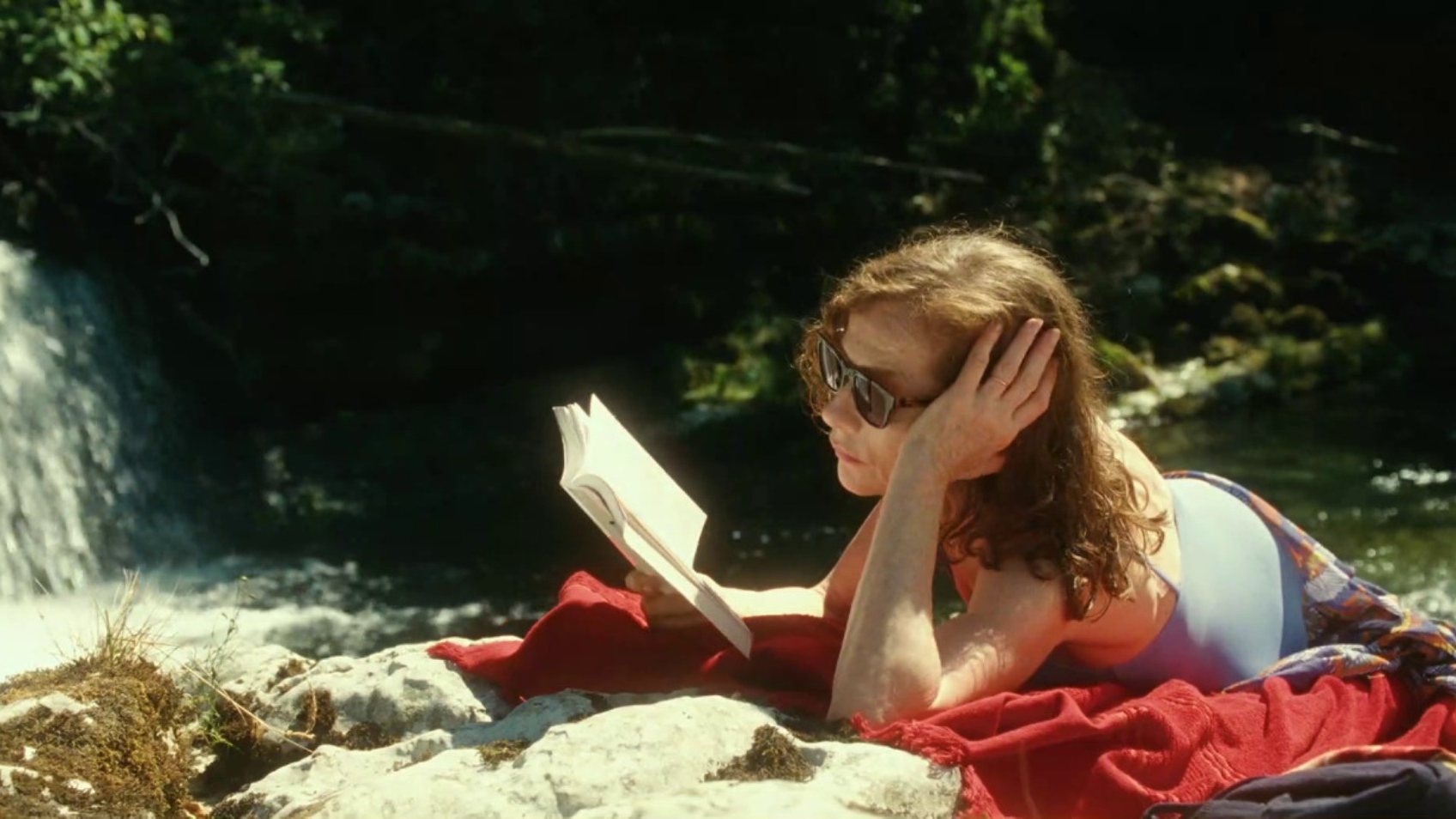 Isabelle Huppert a ler no filme O Que Está Por Vir, de Mia Hansen Love. Imagem IMDB