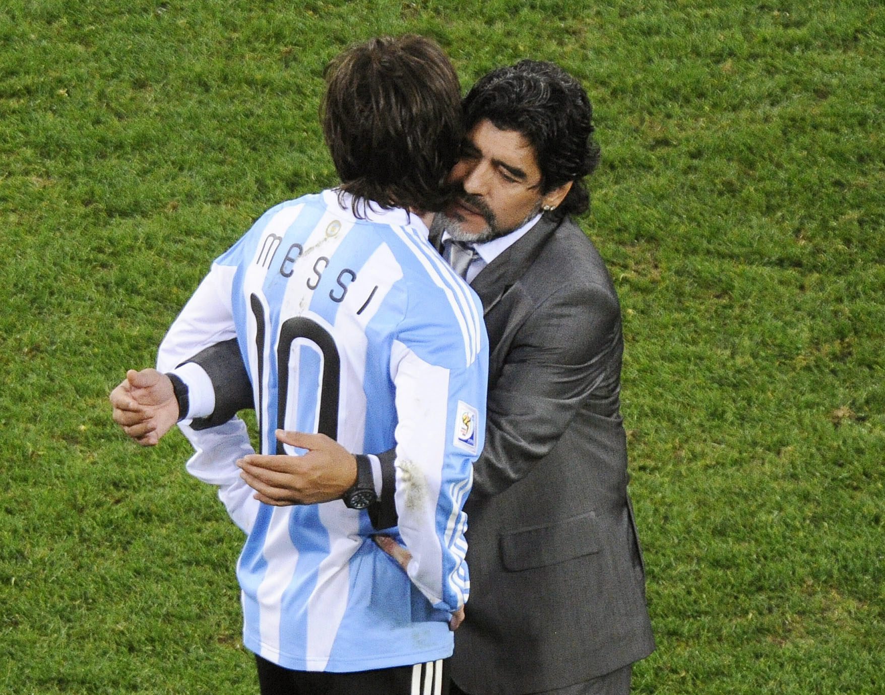 epa02235407 Argentinian national soccer team head coach Diego Maradona (R) hugs his forward Lionel Messi (L) after the FIFA World Cup 2010 quarter final soccer match between Argentina and Germany at the Green Point stadium in Cape Town, South Africa, 03 July 2010. Germany won 4-0 and advanced to the semi final.  EPA/HELMUT FOHRINGER Please refer to www.epa.eu/downloads/FIFA-WorldCup2010-Terms-and-Conditions.pdf