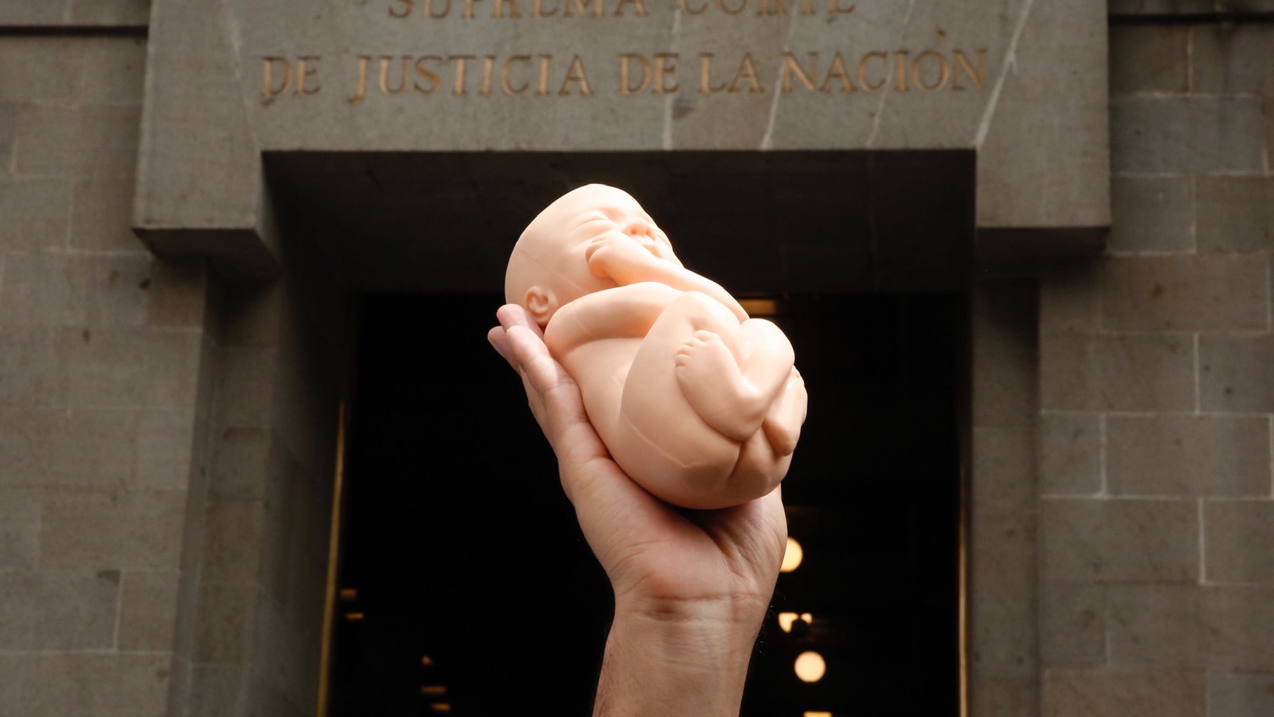 epa09454200 A person lifts a plastic doll in the shape of a baby during a protest by citizens who reject abortion, outside the Supreme Court of Justice of the Nation, in Mexico City, Mexico, 07 September 2021. The Supreme Court of Justice of the Nation (SCJN) of Mexico declared the criminalization of women who abort in the first stage of pregnancy as unconstitutional, and recognized the right to decide in a historic ruling. Unanimously, the ministers of the plenary session of the SCJN invalidated article 196 of the penal code of the northern state of Coahuila, which imposed from one to three years in prison &#039;to the woman who voluntarily performs her abortion or to the person who causes her to have an abortion with her consent&#039;.  EPA/Carlos Ramirez