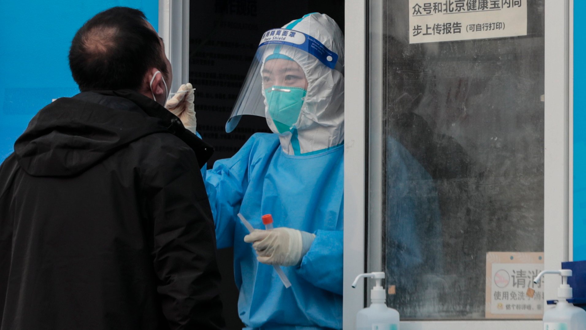 epa09717492 A man undergoes COVID-19 nucleic acid testing in Beijing, China, 30 January 2022. The Chinese mainland on 29 January recorded 54 locally transmitted COVID-19 cases including 20 cases were reported in China&#039;s capital Beijing.  EPA/WU HONG