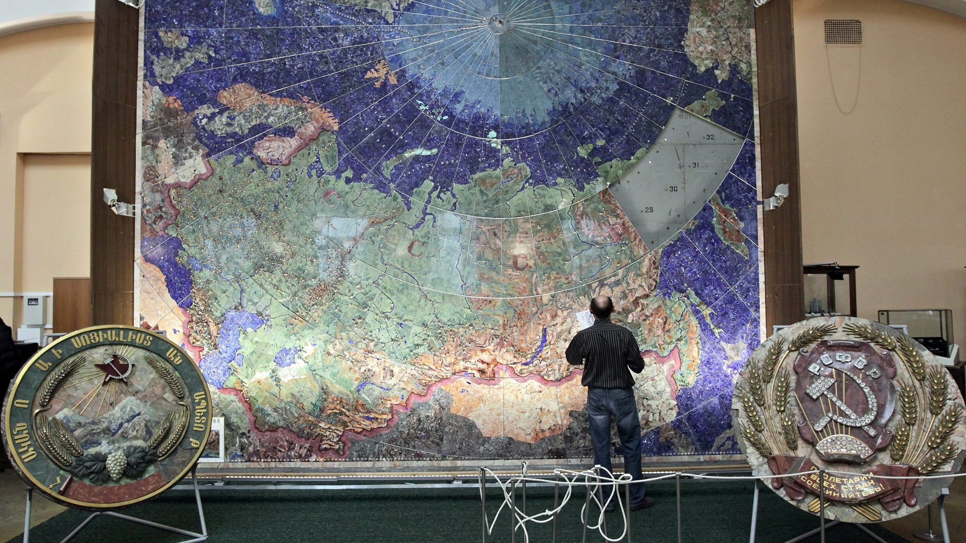 epa02980271 Staff works in a mosaic map of the USSR at the Russian Geological Research Institute (VSEGEI) in St.Petersburg, Russia, 25 October 2011. The mosaic currently under restoration is made of a set of 45,000 plates jasper, lapis lazuli, amazonite and rhodonite, originally pasted on textolite basis. Cities and towns are marked with gilded silver stars with inserts of artificial rubies. Line parallels, meridians, railroads, and all the place names are made of platinized silver.  EPA/ANATOLY MALTSEV