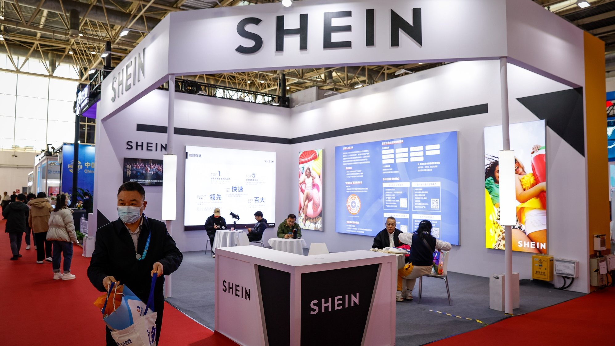 epa11000490 A man walks next to a Shein booth during the China International Supply Chain Expo in Beijing, China, 29 November 2023. China is holding its first China International Supply Chain Expo in Beijing from 28 November to 02 December with the theme of &#039;Connecting the World for a Shared Future&#039;.  EPA/MARK R. CRISTINO