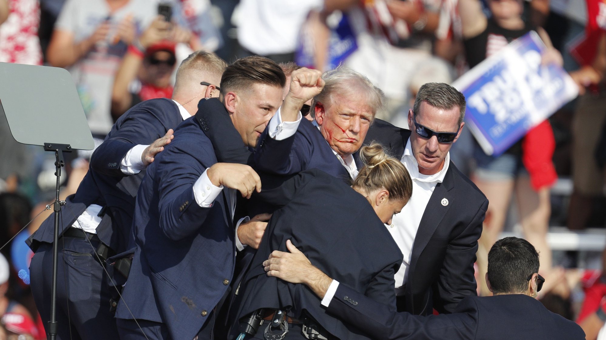 epa11476746 Former US President Donald Trump is rushed off stage by secret service after an incident during a campaign rally at the Butler Farm Show Inc. in Butler, Pennsylvania, USA, 13 July 2024.  EPA/DAVID MAXWELL